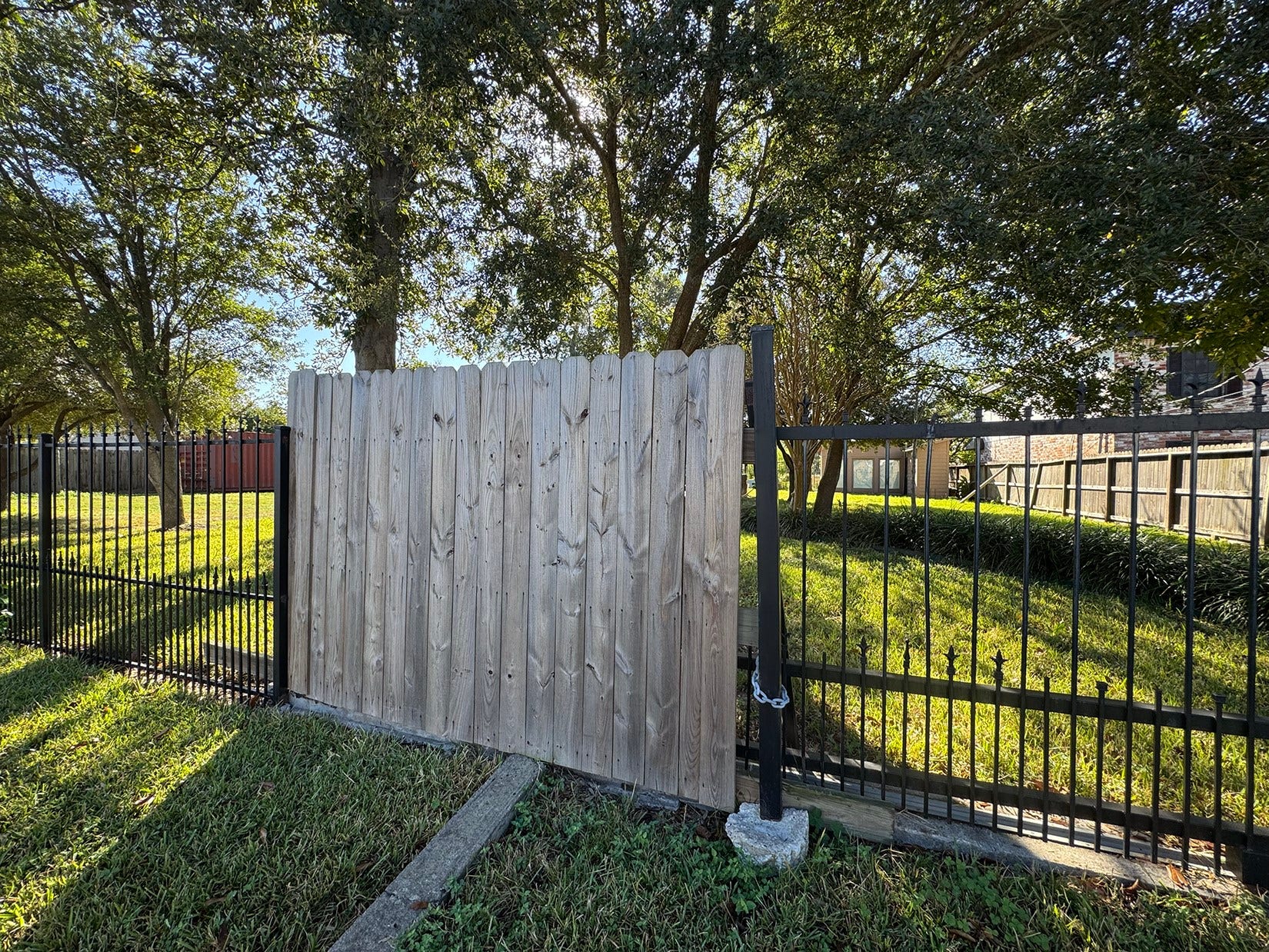 The space is grassy and shaded by mature trees, creating a tranquil outdoor environment.