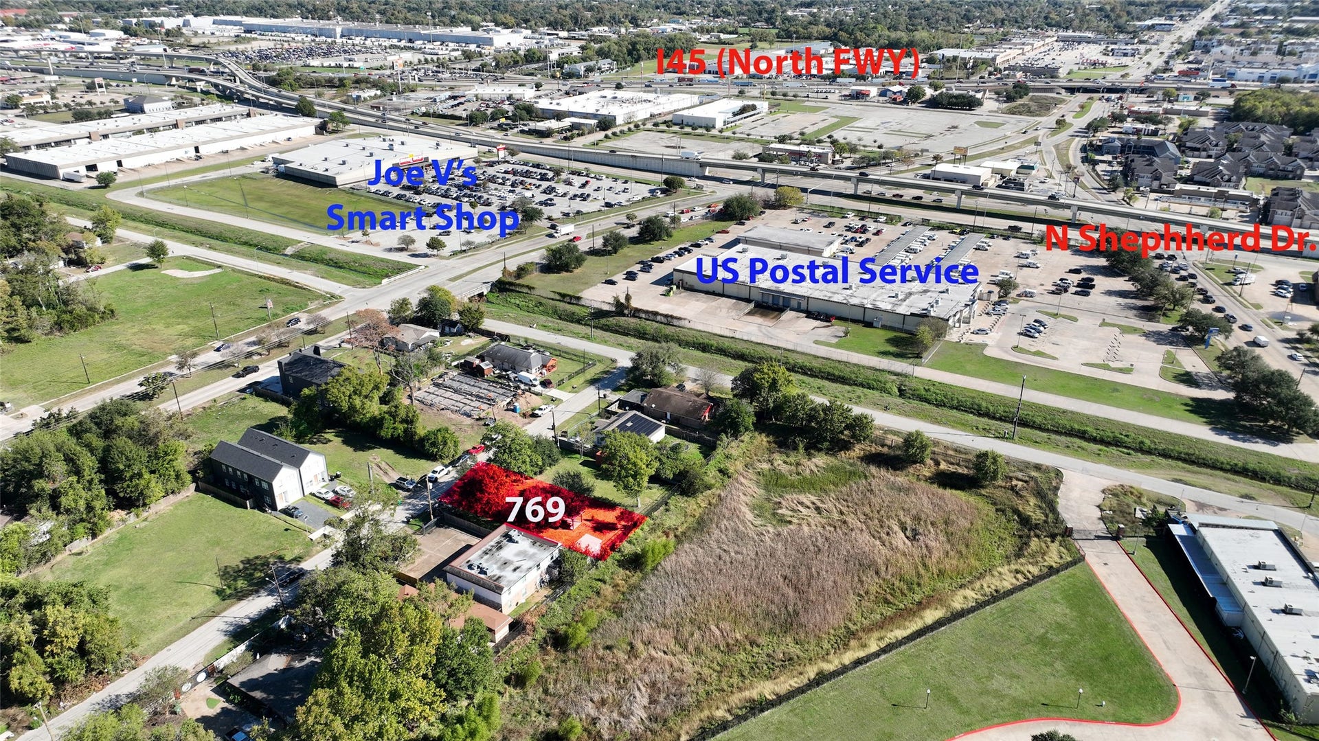 This aerial photo showcases a property highlighted in red, located near major roads including I-45 (North Fwy) and N Shepherd Dr. The area is in proximity to amenities such as Joe V's Smart Shop and a US Postal Service facility, offering convenience for daily needs. The surroundings include residential and commercial spaces, making it a potentially strategic location.