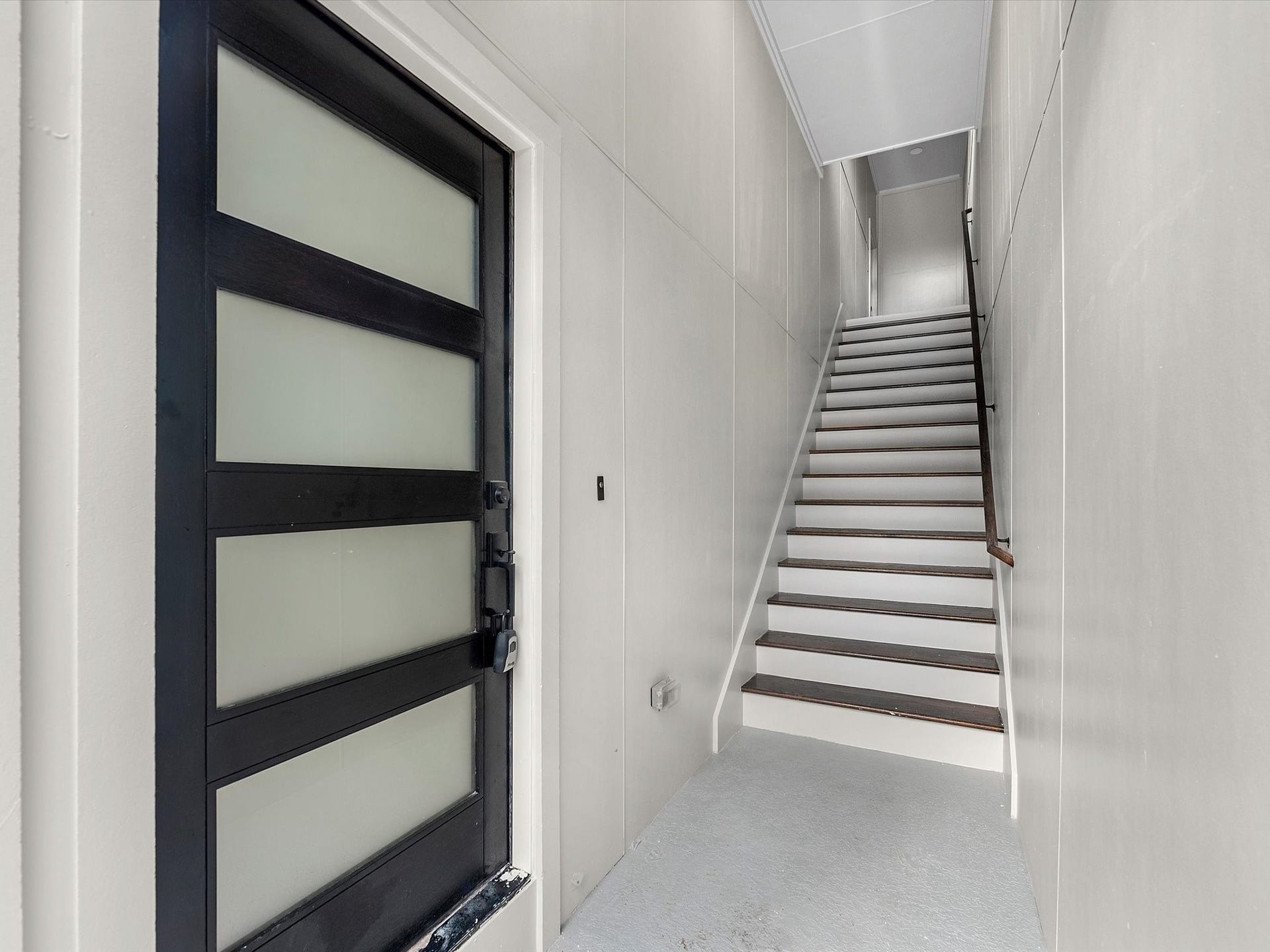3307 Delhi Street, Houston, TX 77022 Stairs to Unit 2 on second floor, stained wood step stairs,