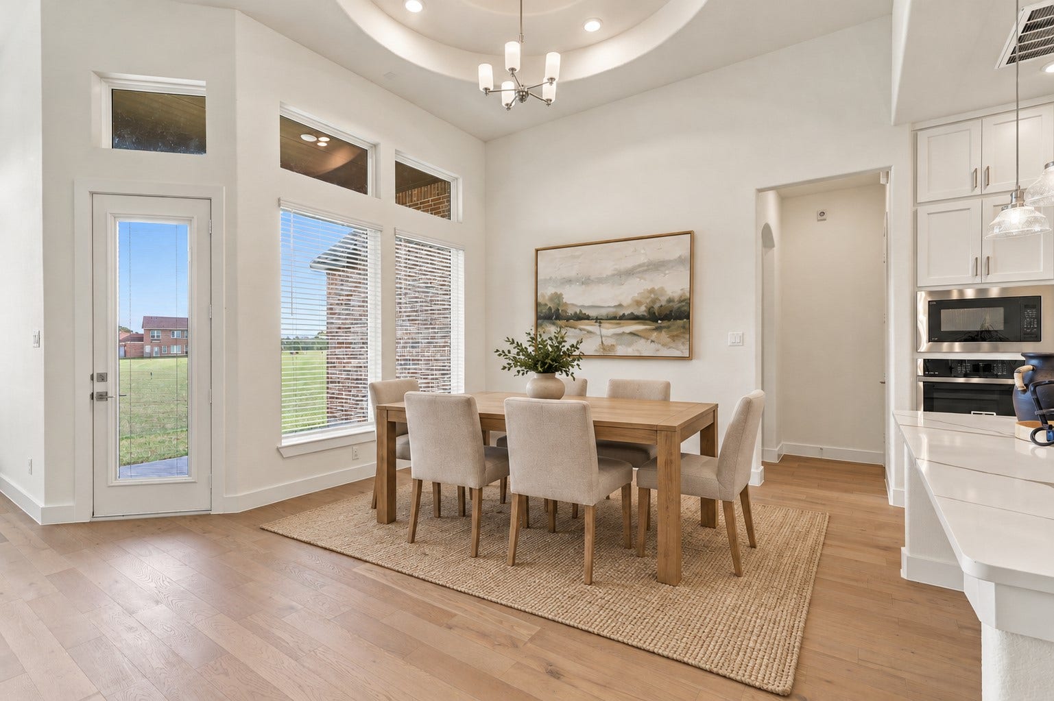 1051 Lakeland Circle, Rosharon, TX 77583 WHAT A BEAUTIFUL PLACE TO GATHER & MAKE MEMORIES! Imagine hosting WONDERFUL FAMILY DINNERS, festive holiday celebrations & unforgettable gatherings in this ELEGANT DINING AREA! A DRAMATIC CEILING DESIGN and STUNNING STATEMENT CHANDELIER create an impressive first impression, while LARGE WINDOWS welcome an abundance of BEAUTIFUL NATURAL LIGHT! GORGEOUS ENGINEERED WOOD FLOORING adds warmth, sophistication & timeless charm! Virtual Stage!