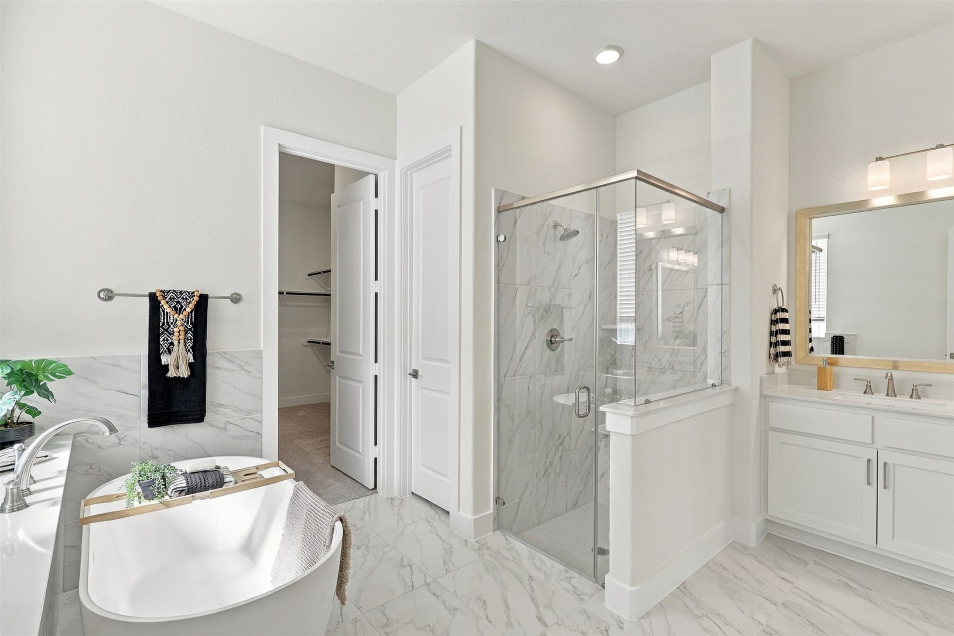 1051 Lakeland Circle, Rosharon, TX 77583 STEP INTO YOUR OWN PRIVATE SPA! This SPECTACULAR primary bathroom offers the best of both worlds with a relaxing soaking tub, separate glass-enclosed shower, and an expansive double-sink vanity! Beautiful tile flooring, crisp white cabinetry, and bright finishes create a clean, elegant atmosphere! What a WONDERFUL way to start and end your day!