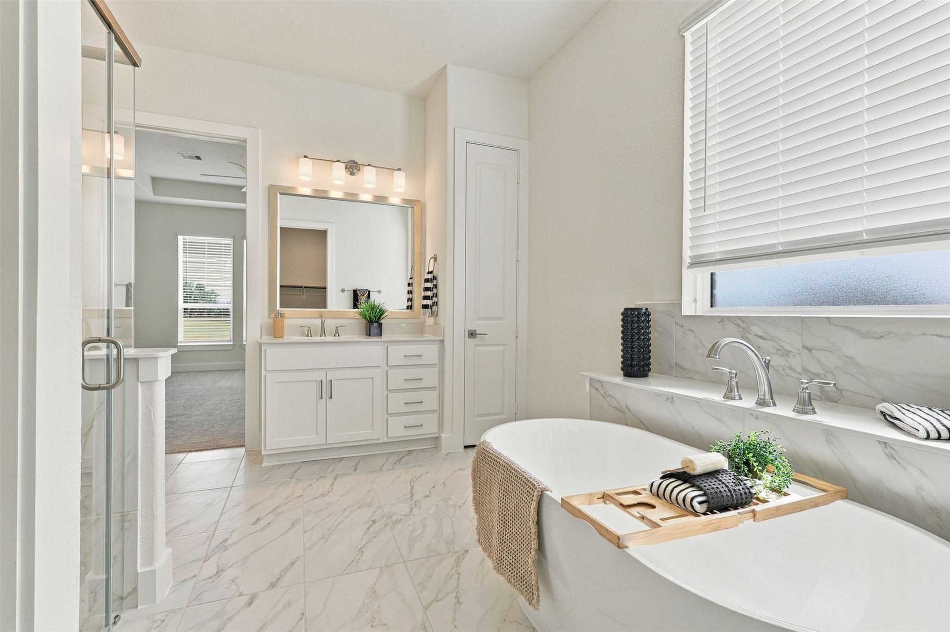 1051 Lakeland Circle, Rosharon, TX 77583 RELAXATION STARTS HERE! Imagine soaking your cares away in this BEAUTIFUL DEEP SOAKING TUB, perfectly positioned beneath a FROSTED GLASS WINDOW welcoming soft natural light while maintaining privacy! GORGEOUS TILE FLOORING, a SPACIOUS PRIVATE VANITY with SPARKLING QUARTZ COUNTERTOPS, DEEP UNDERMOUNT SINK & an ABUNDANCE OF CABINETS & DRAWERS! AND THERE'S MORE! Enjoy a CONVENIENT LINEN PANTRY for even more storage! YOUR OWN SPA-INSPIRED ESCAPE awaits!