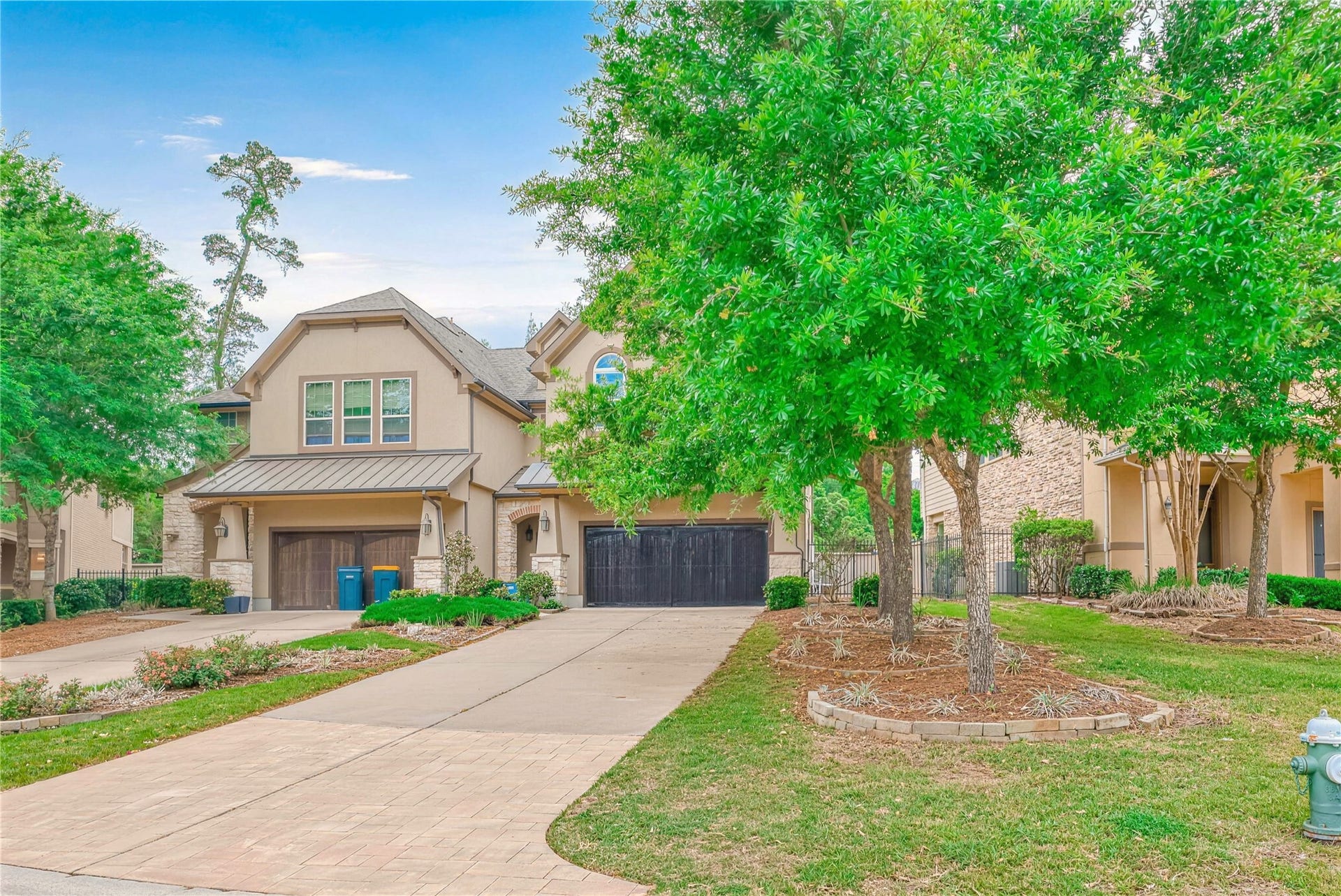 19 Herons Flight Place, Spring, TX 77389 Charming two-story home with a spacious driveway, lush landscaping, and mature trees offering ample shade and curb appeal.