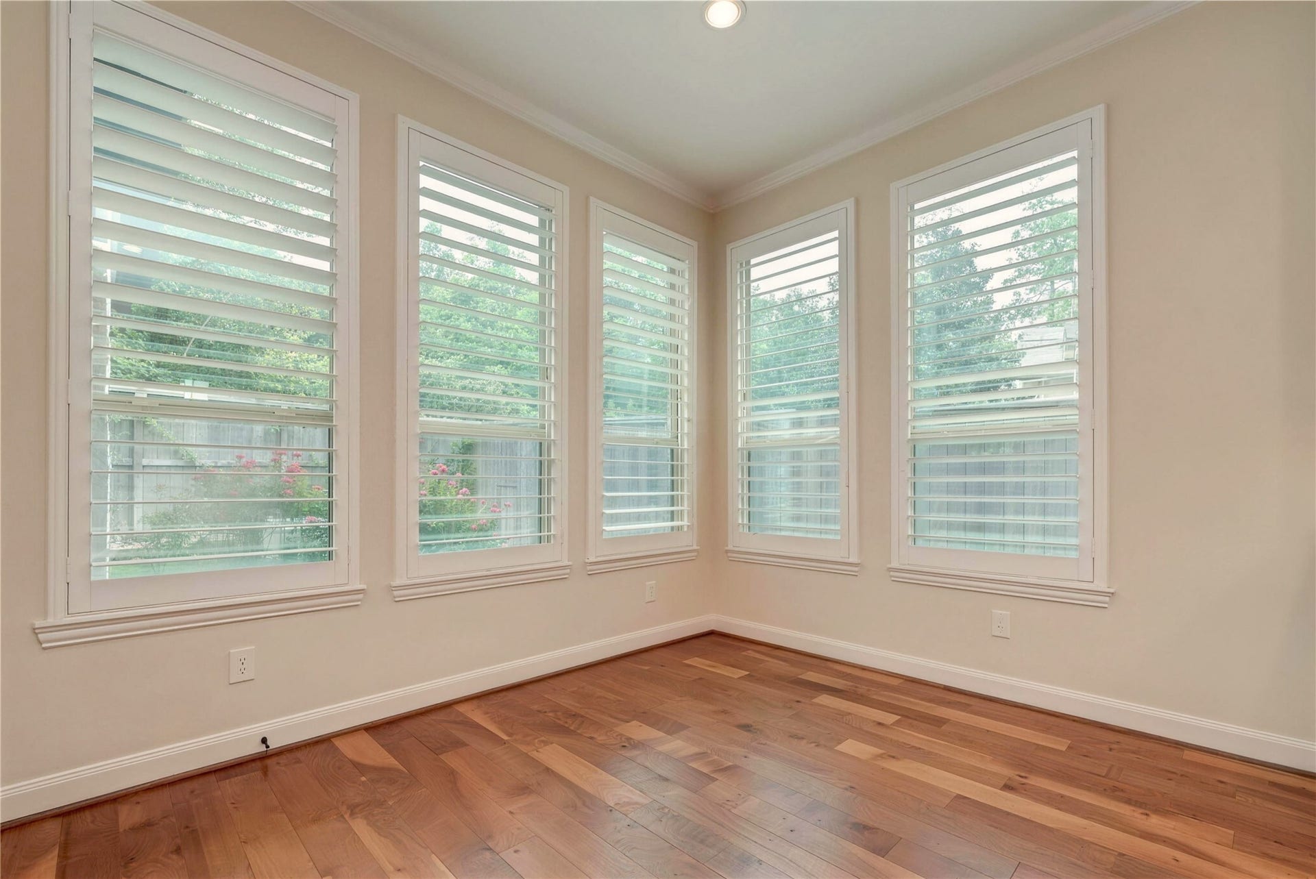 19 Herons Flight Place, Spring, TX 77389 Bright and inviting space with large windows featuring plantation shutters, offering plenty of natural light and a view of the garden.