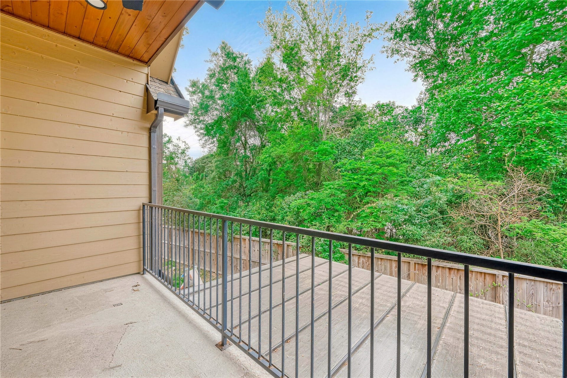 19 Herons Flight Place, Spring, TX 77389 Enjoy serene views of lush greenery from this spacious balcony, perfect for relaxation and outdoor enjoyment.