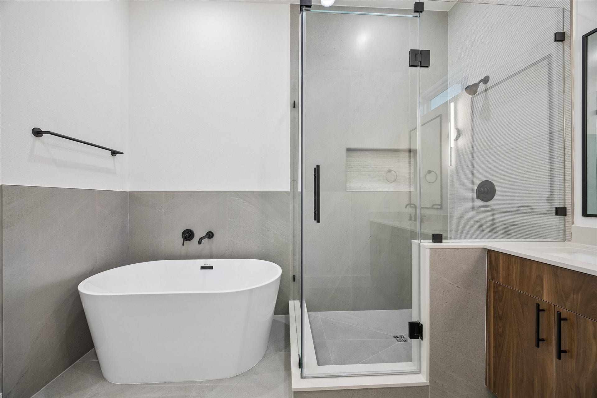 Primary bath detail showcasing tub, shower, and refined finishes