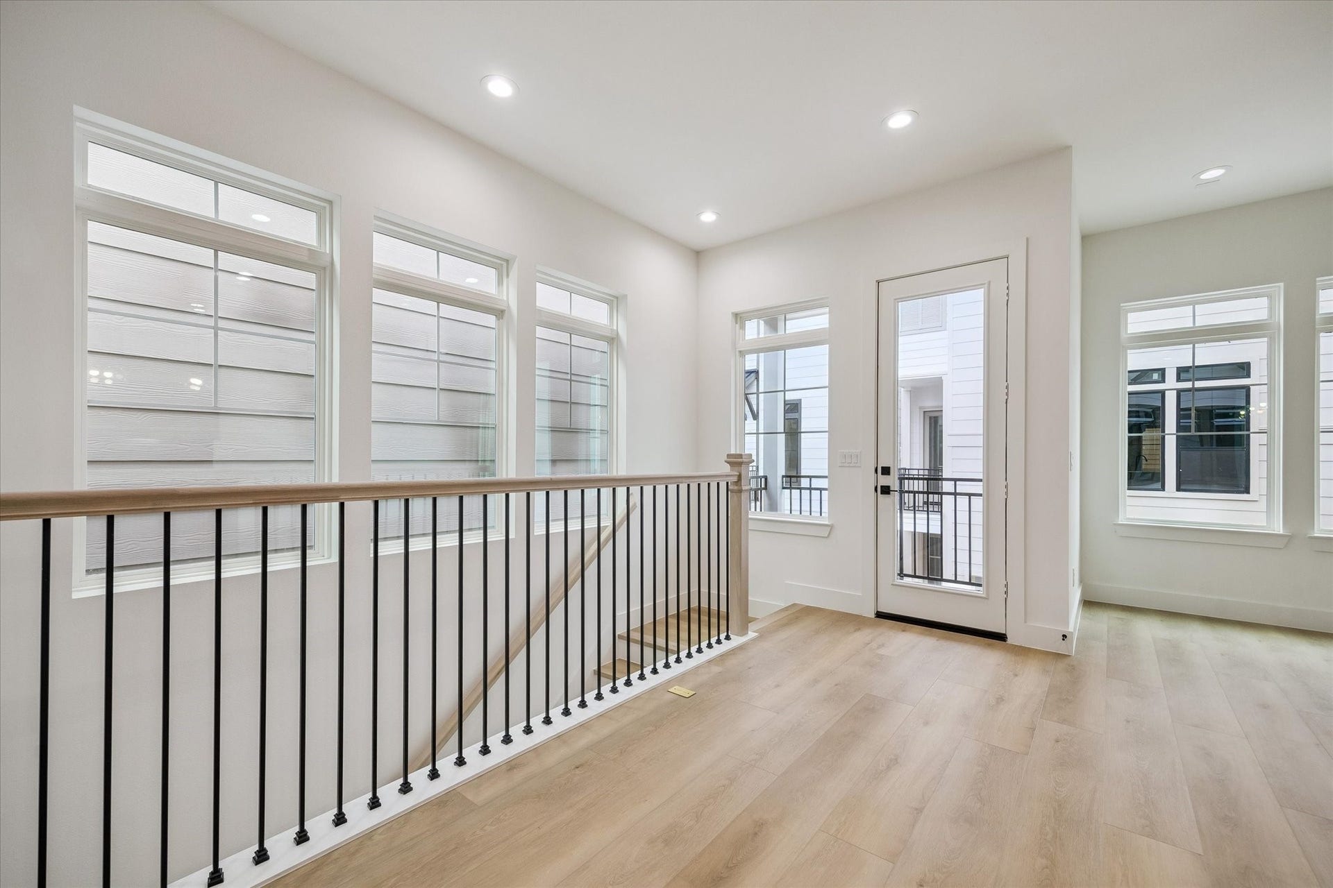 Airy upstairs landing offering flexible use and generous window light