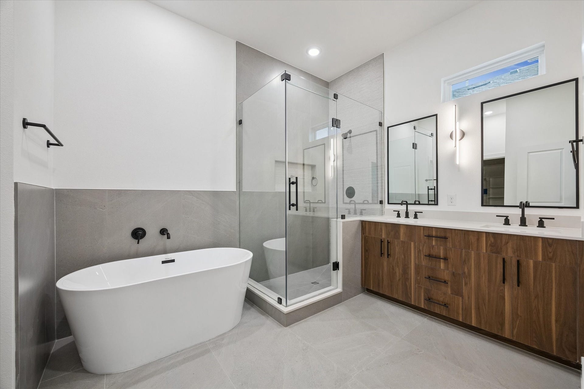 Primary bath with freestanding tub, glass shower, and spa-like feel