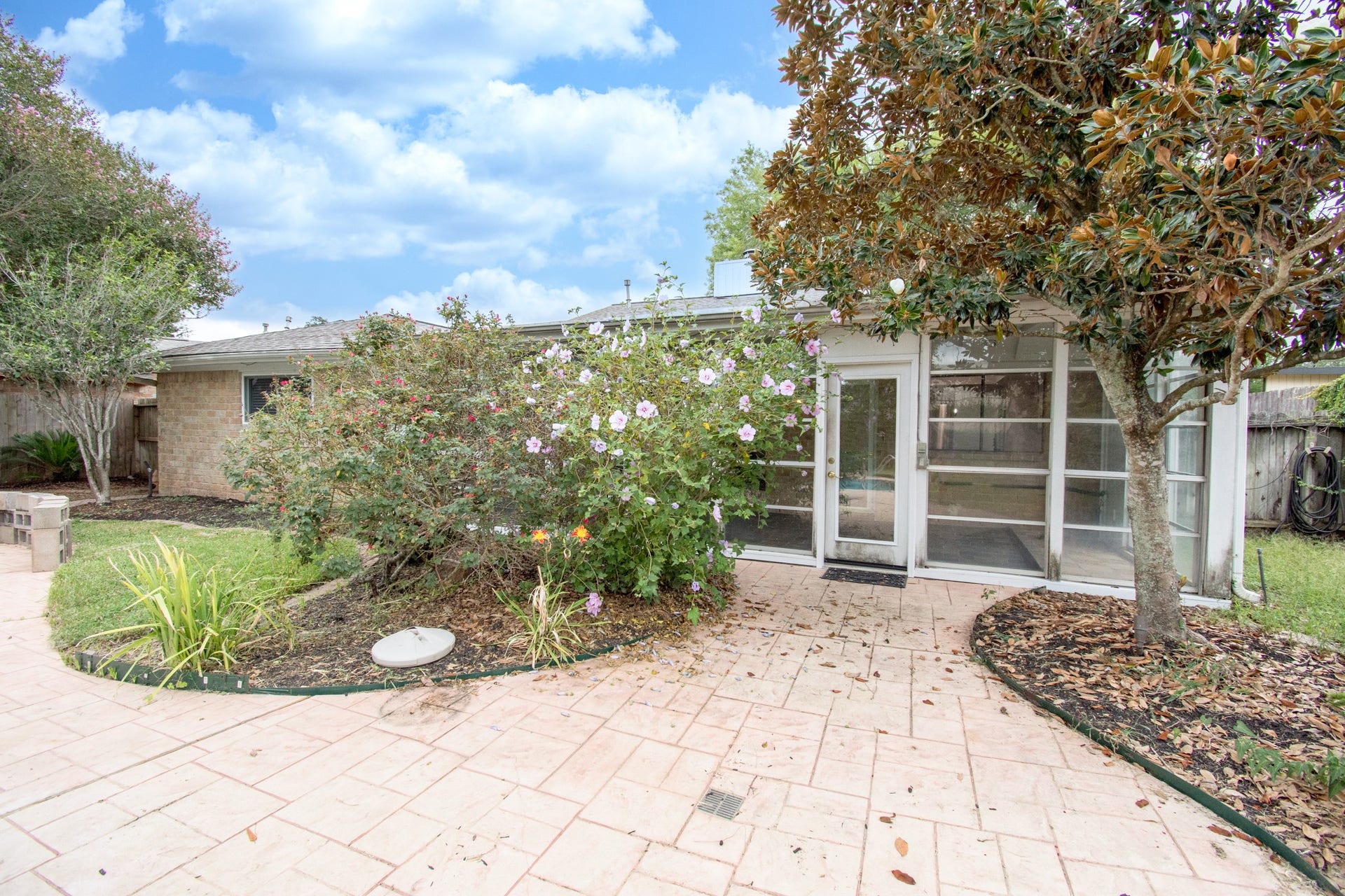 2507 Sage Brush Lane, Sugar Land, TX 77479 Sprinkler system, extensive stamped concrete decking and mature trees!