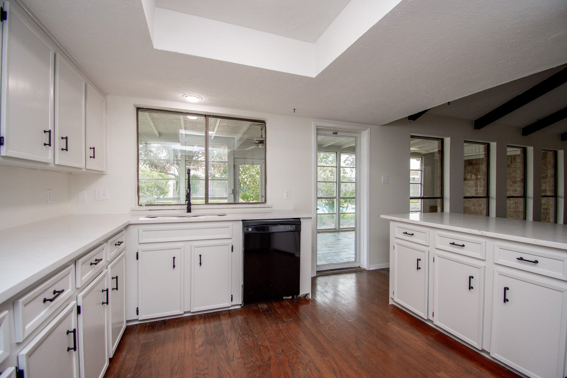 2507 Sage Brush Lane, Sugar Land, TX 77479 Bright white kitchen with hardwood floors.