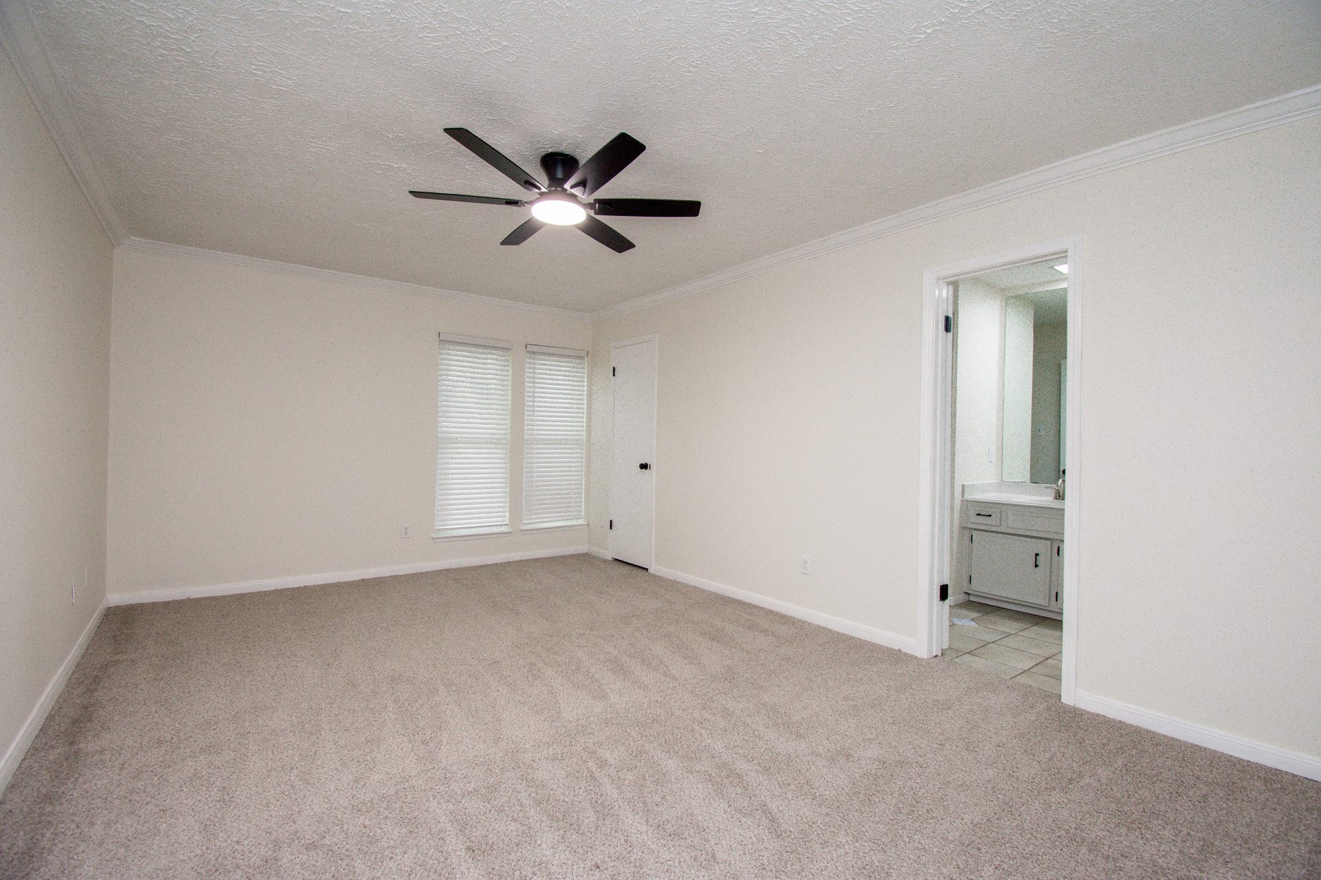 2507 Sage Brush Lane, Sugar Land, TX 77479 Primary bedroom with ceiling fan, sitting area and fresh paint