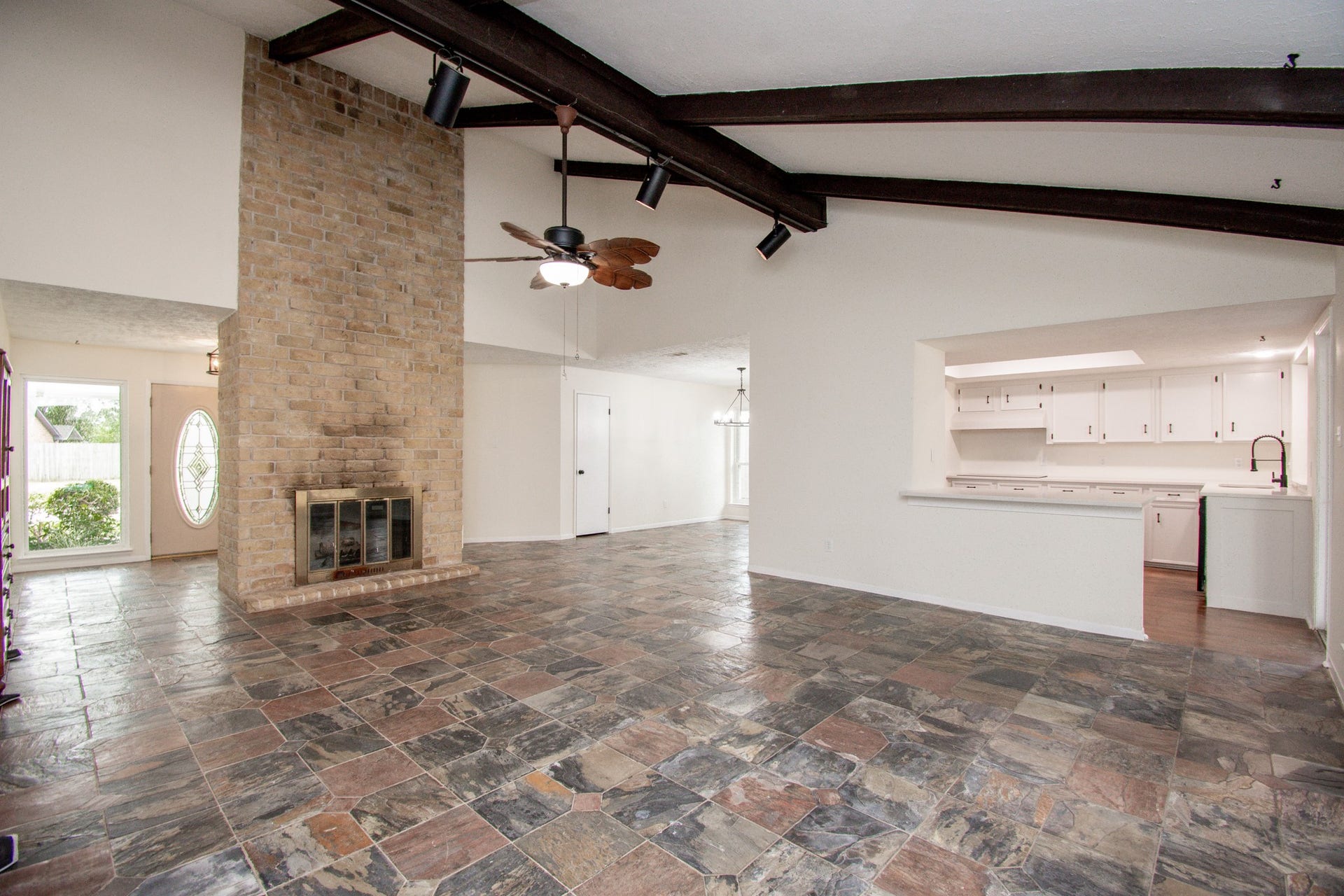 2507 Sage Brush Lane, Sugar Land, TX 77479 Living room features slate tile floors, wood beams in the vaulted ceiling!