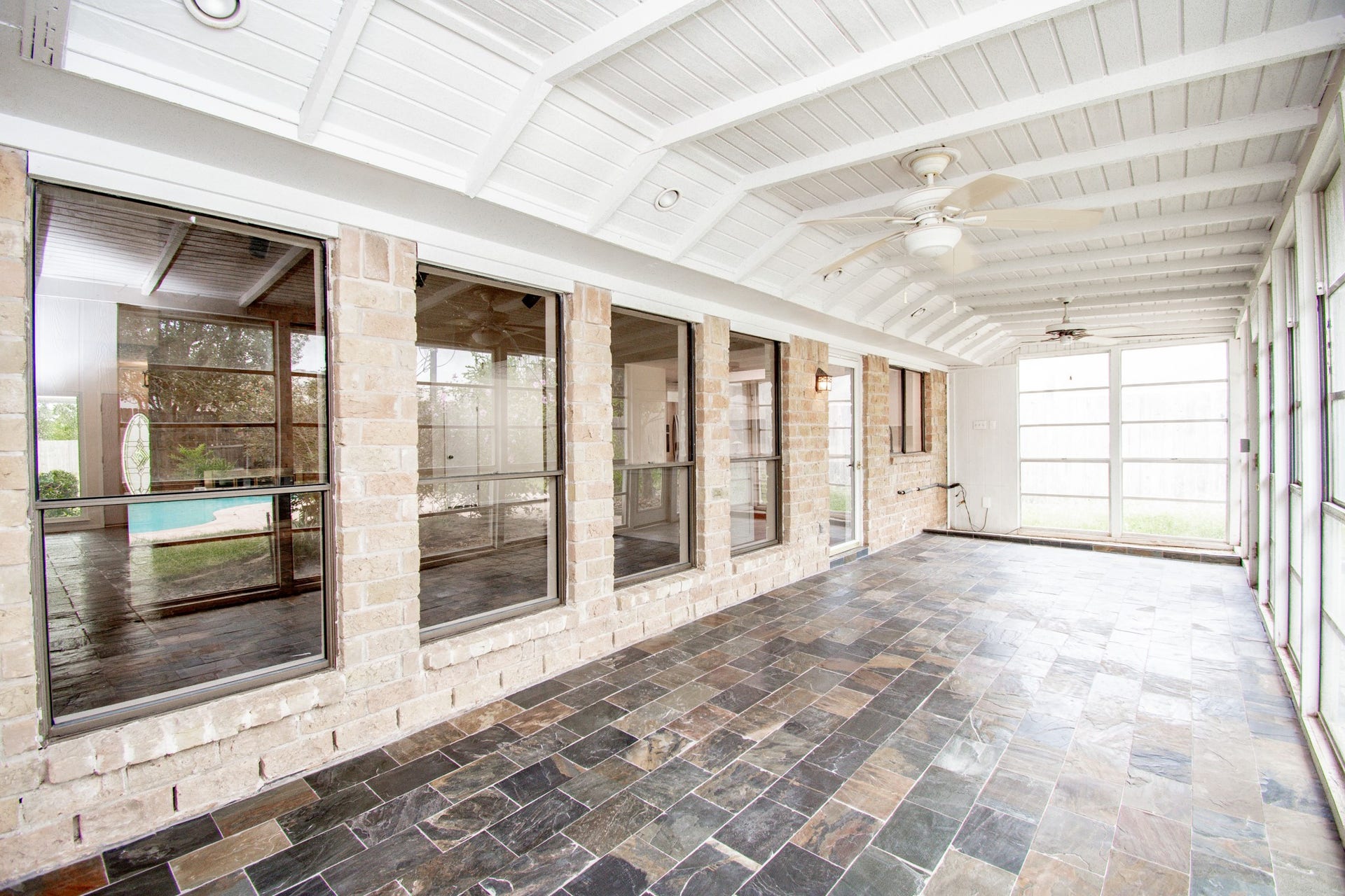 2507 Sage Brush Lane, Sugar Land, TX 77479 Enclosed sunroom with slate tile, ceiling fans and planter space for the plant lover