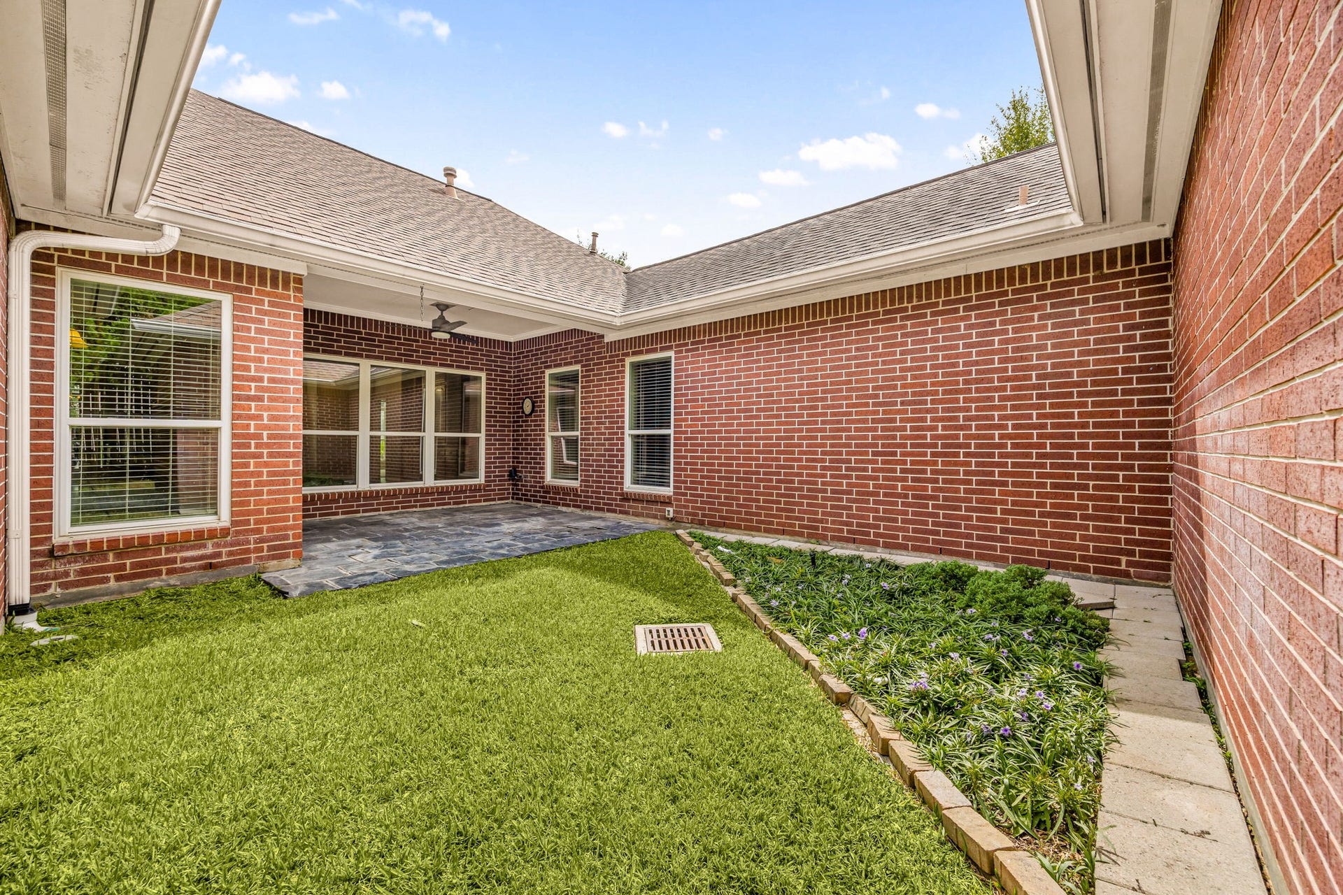 1602 Hannington Drive, Katy, TX 77450 Tucked between the home's different wings, this private courtyard creates another outdoor sitting area beneath the mature trees.