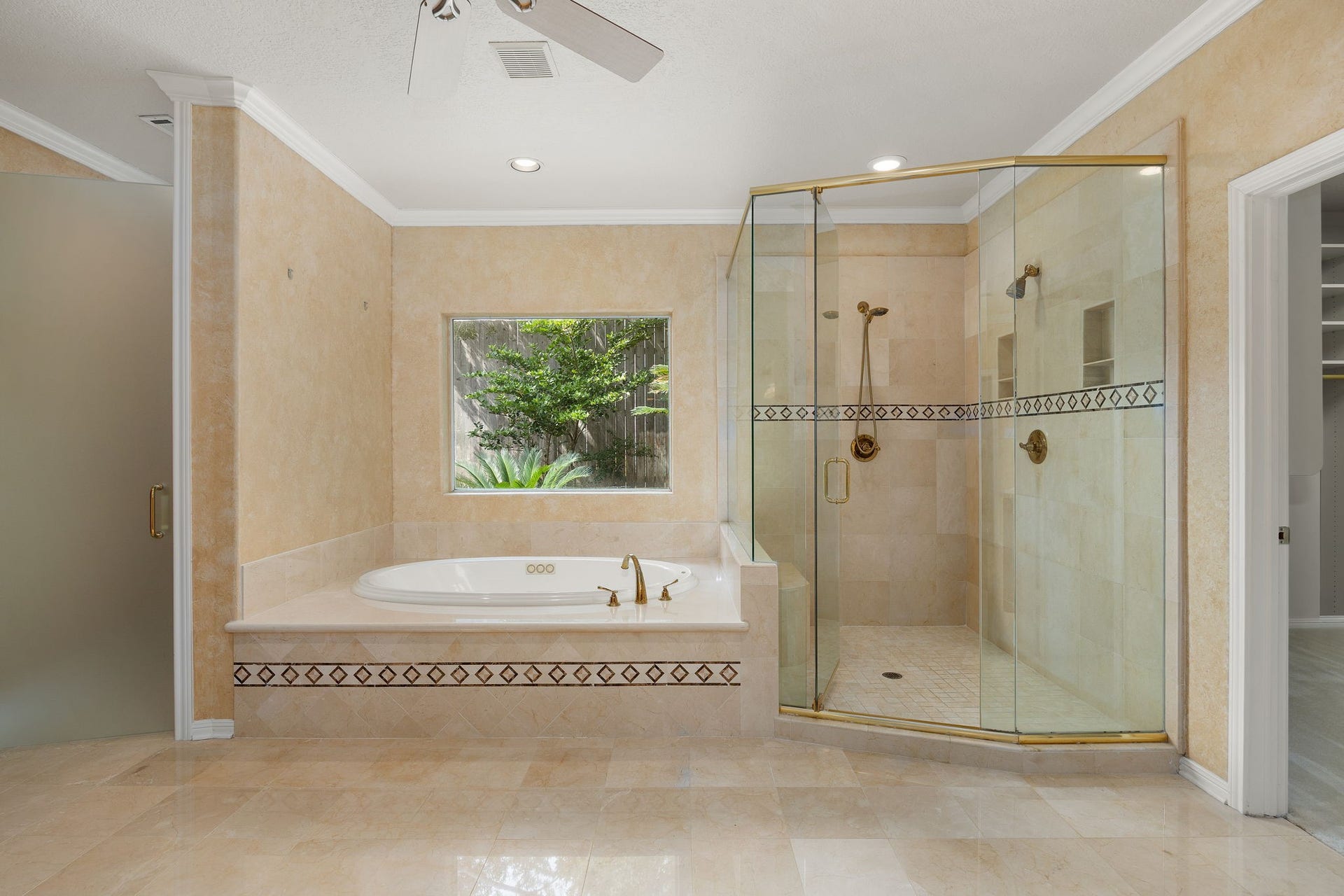1602 Hannington Drive, Katy, TX 77450 A garden window fills the soaking-tub area with natural light while a separate glass-enclosed shower completes the remodeled bath.