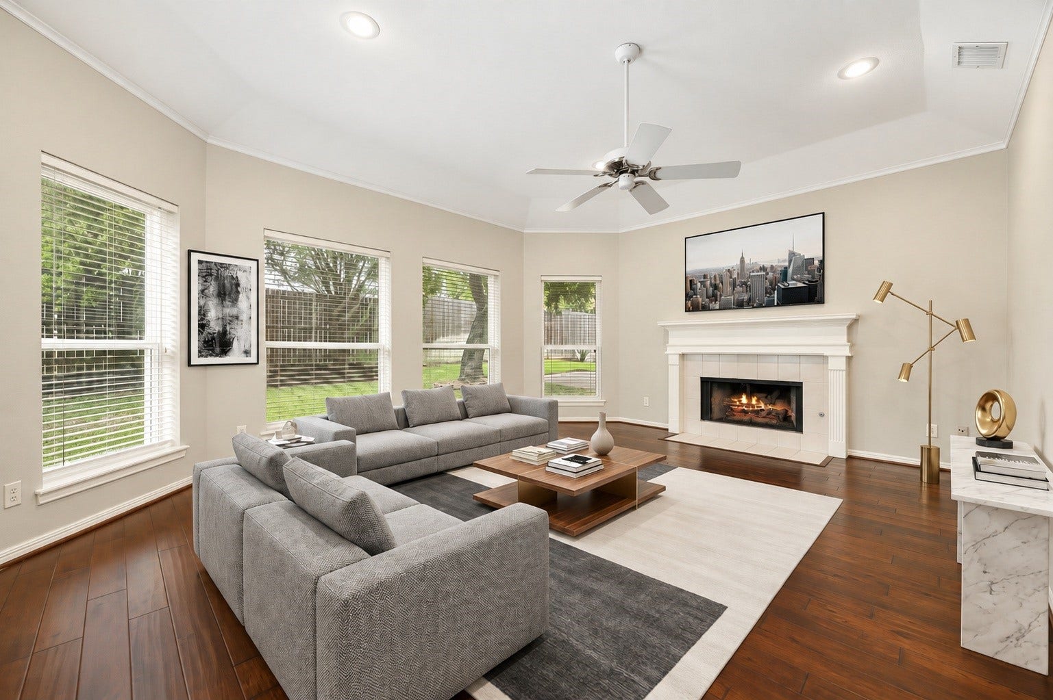1602 Hannington Drive, Katy, TX 77450 The family room centers around a gas-log fireplace, with oversized windows looking out across the backyard. Virtually staged.