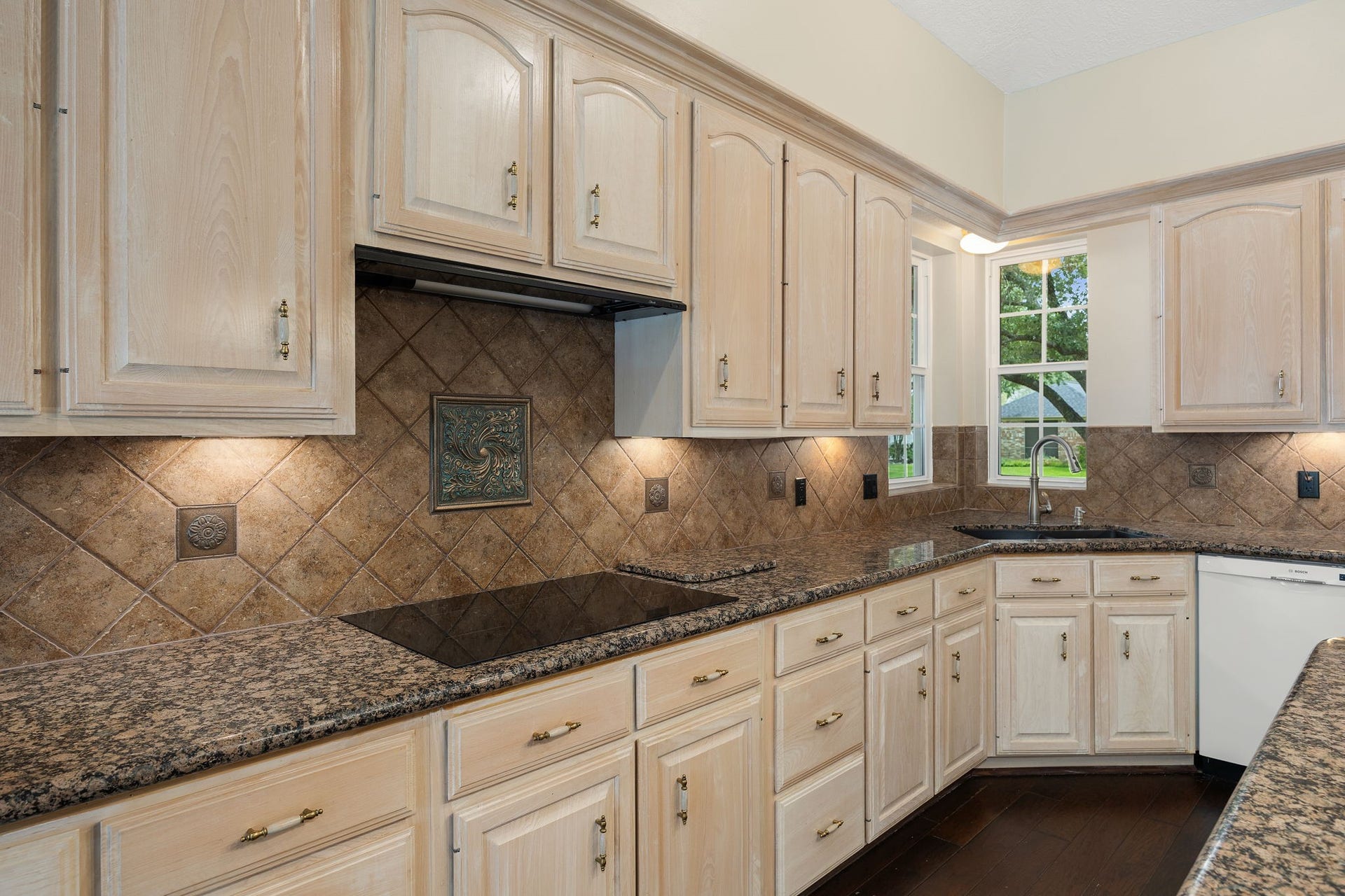 1602 Hannington Drive, Katy, TX 77450 Granite counters, an induction cooktop and under-cabinet lighting add function to a kitchen designed with storage in mind.