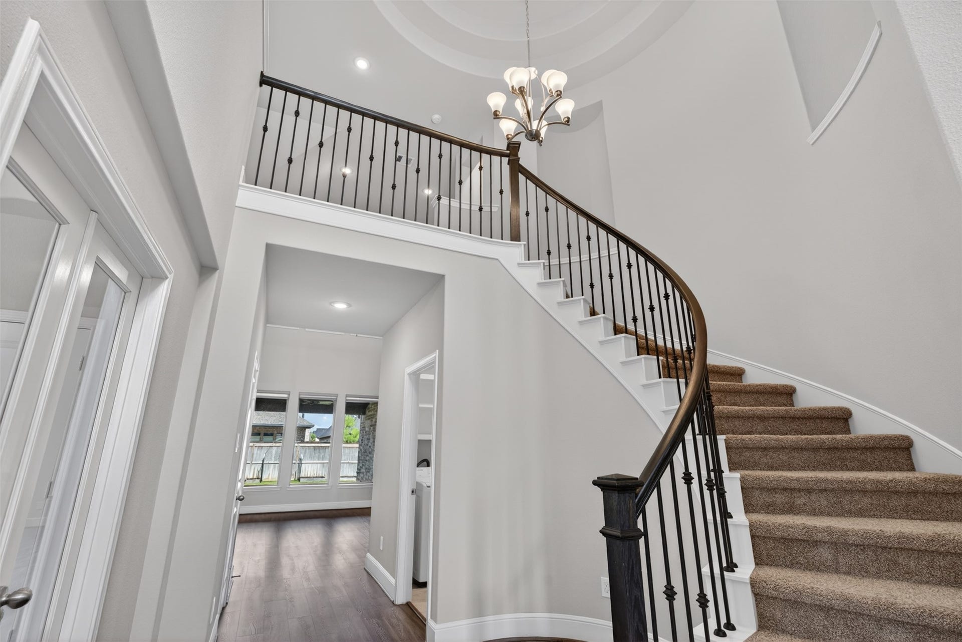 As you continue through the home, past the home office, the staircase serves as a striking architectural focal point, drawing the eye upward with its graceful design and open feel. Thoughtfully positioned, it creates a seamless connection between the main living spaces and the expansive second floor. The elegant lines and airy layout add to the home's sense of sophistication and spaciousness.