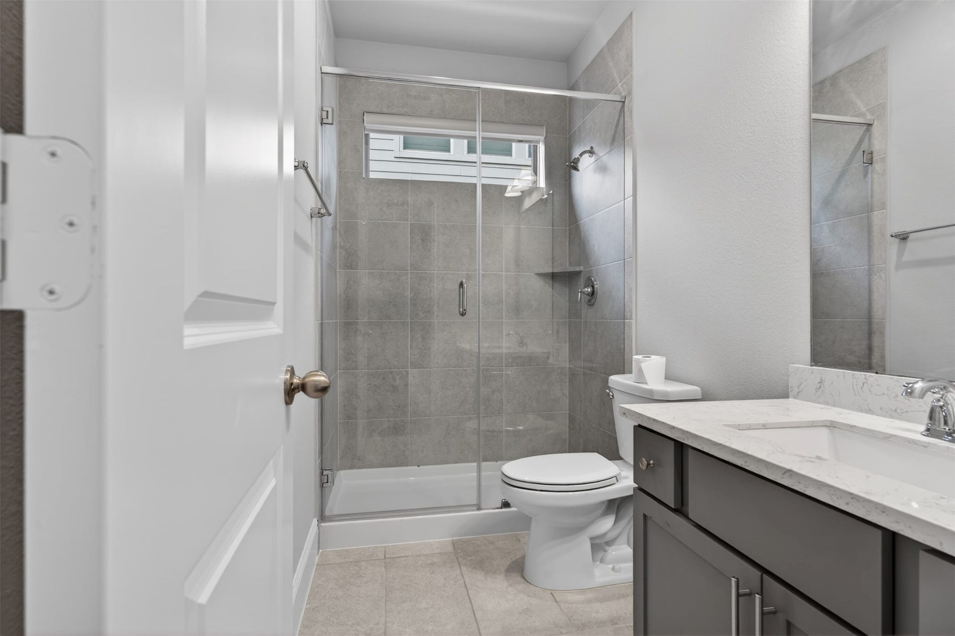 Just steps away, the secondary full bathroom is thoughtfully appointed with modern finishes and timeless design elements. Designed with both beauty and functionality in mind, it provides a comfortable and convenient space for family members and guests alike.