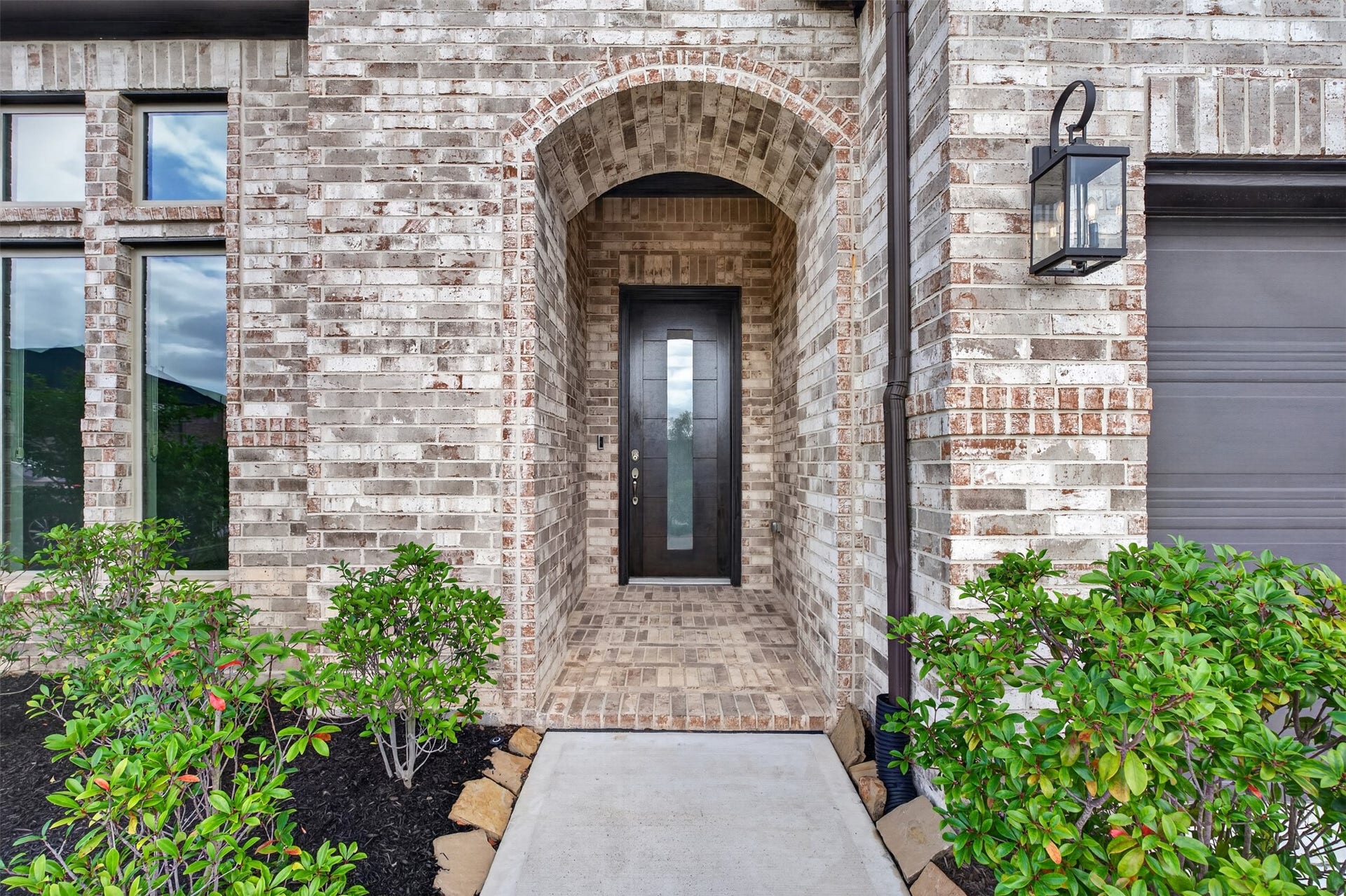 Step through the arched covered entry and experience a grand welcome. The recessed front porch provides architectural character while offering protection from the elements. It's the perfect introduction to the elegance and comfort found throughout the home.
