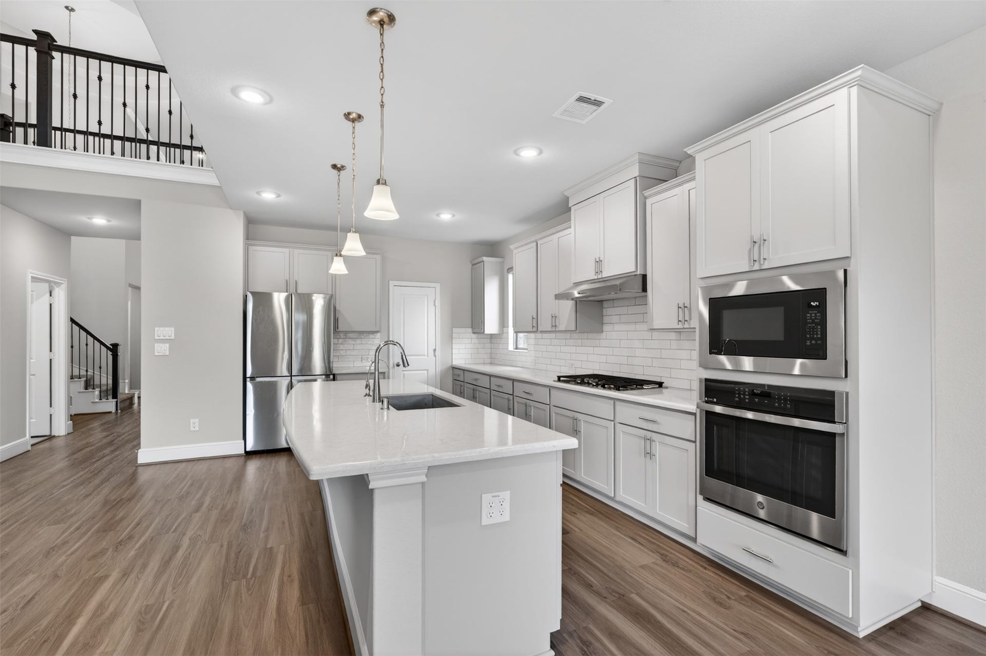 Designed with both beauty and functionality in mind, the kitchen offers abundant cabinetry, generous counter space, and a thoughtful layout ideal for daily living and entertaining.