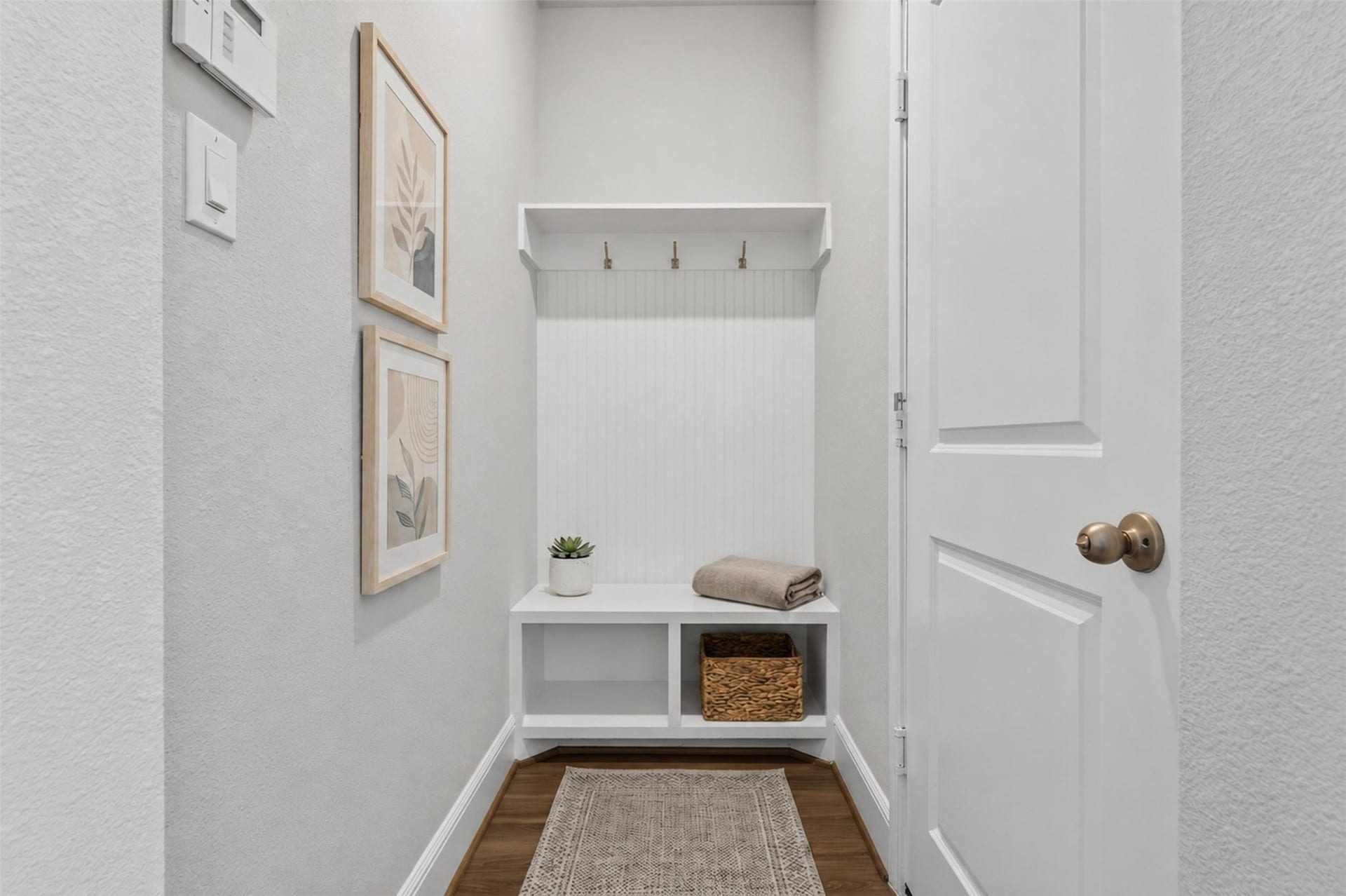Conveniently located just inside the garage entry, the built-in mud area offers a practical and stylish solution for everyday organization.
