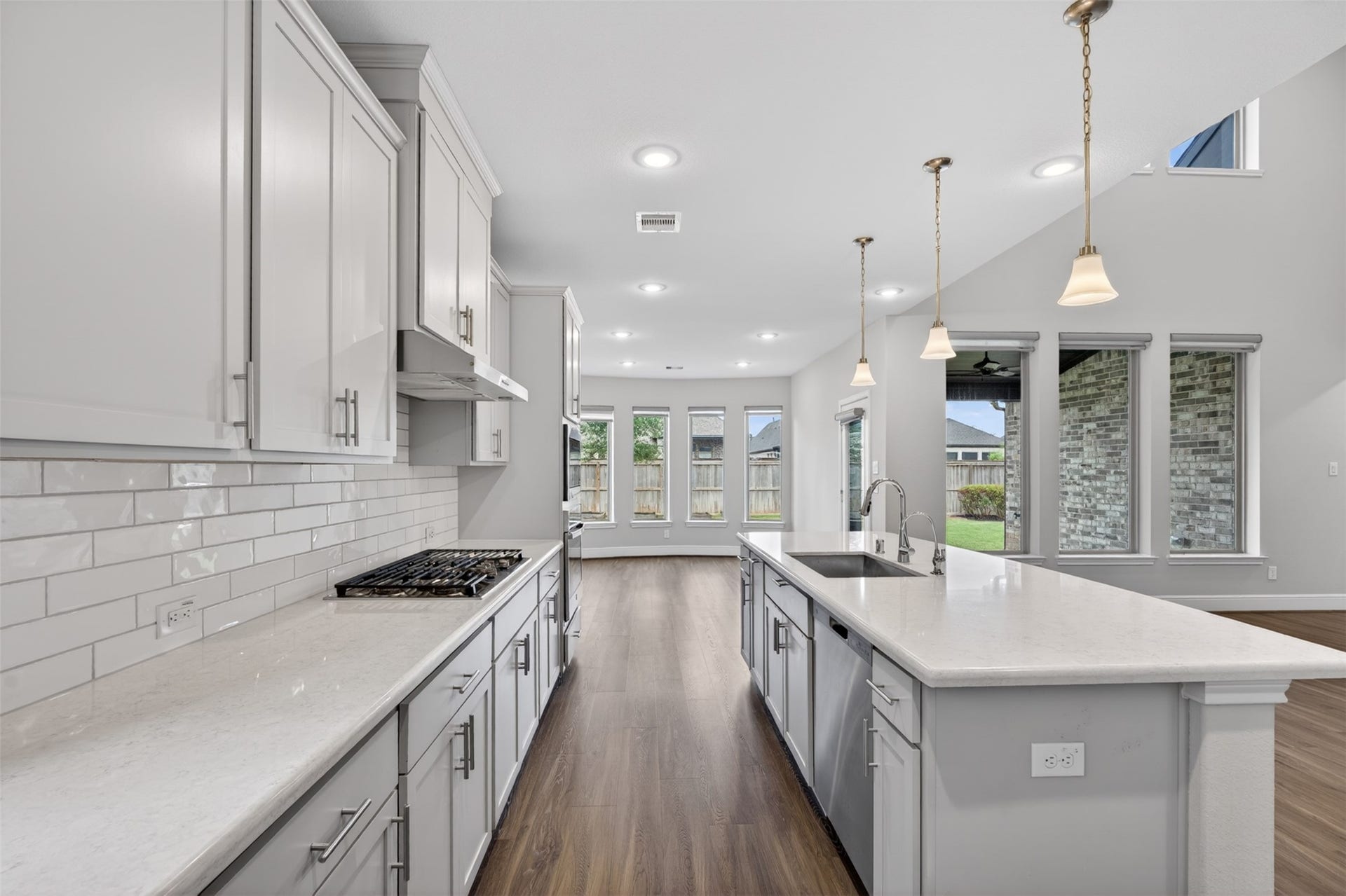 The tile backsplash brings subtle texture and visual interest. Whether preparing meals or entertaining guests, the kitchen delivers both style and convenience.