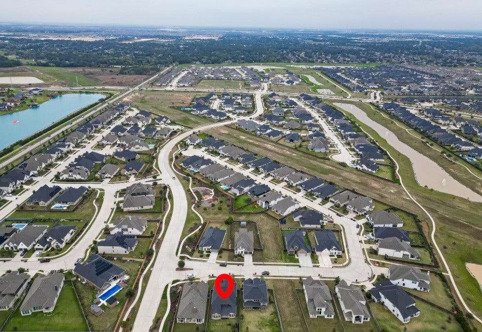 This bird's-eye view provides a comprehensive look at the home's footprint, lot size, and surrounding green space.