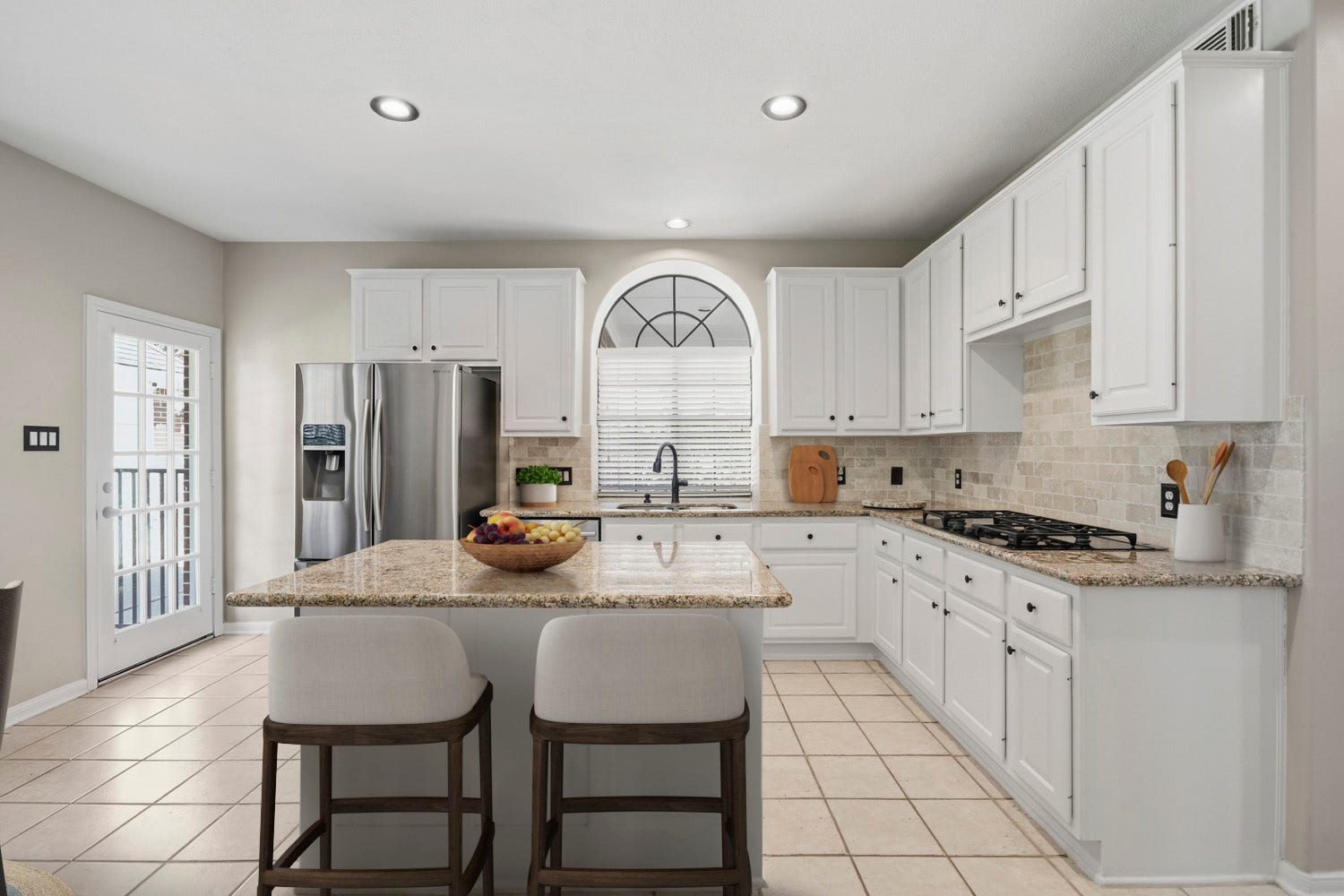 16 Fosters Court, Sugar Land, TX 77479 Virtually Staged: This bright and spacious kitchen features crisp white cabinetry, granite countertops, stainless steel appliances, and a large center island offering additional prep and serving space.