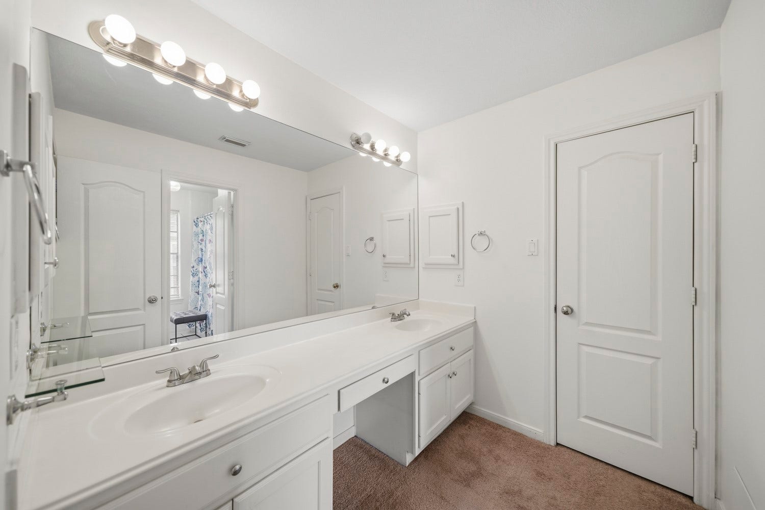 16 Fosters Court, Sugar Land, TX 77479 This bright and spacious bathroom vanity area features a long dual-sink counter with abundant cabinetry and an oversized wall-to-wall mirror. Multiple vanity lights keep the space well illuminated, while the generous counter space and separate getting-ready area provide added functionality for everyday routines.