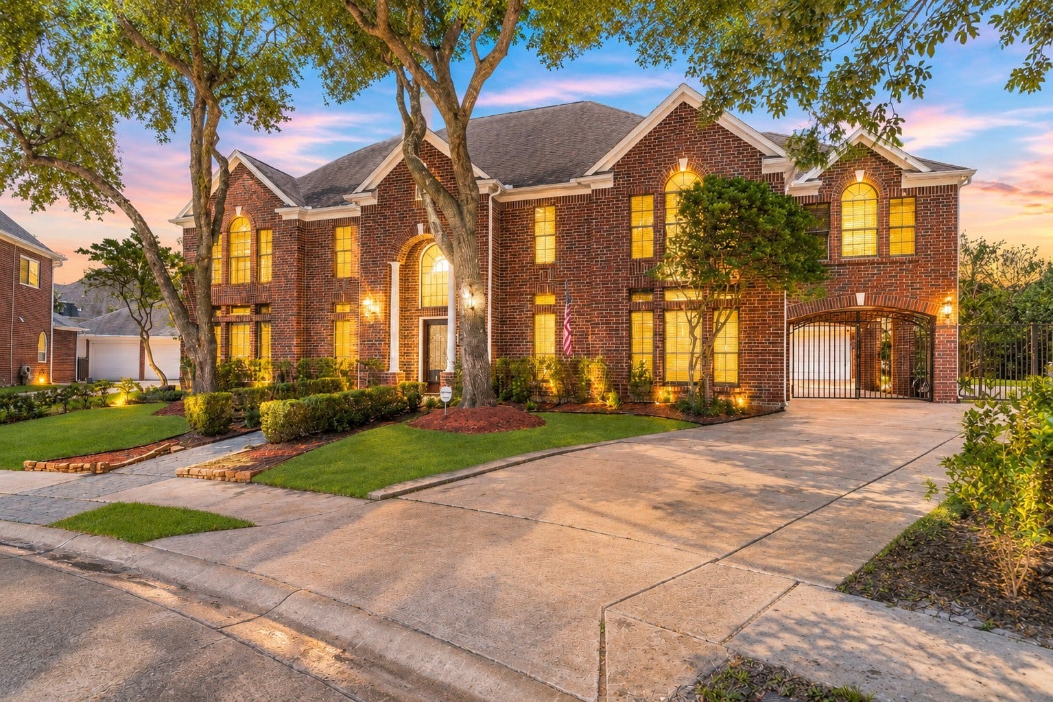 16 Fosters Court, Sugar Land, TX 77479 This impressive two-story custom brick home offers striking curb appeal with mature shade trees, manicured landscaping, and a grand arched entry.