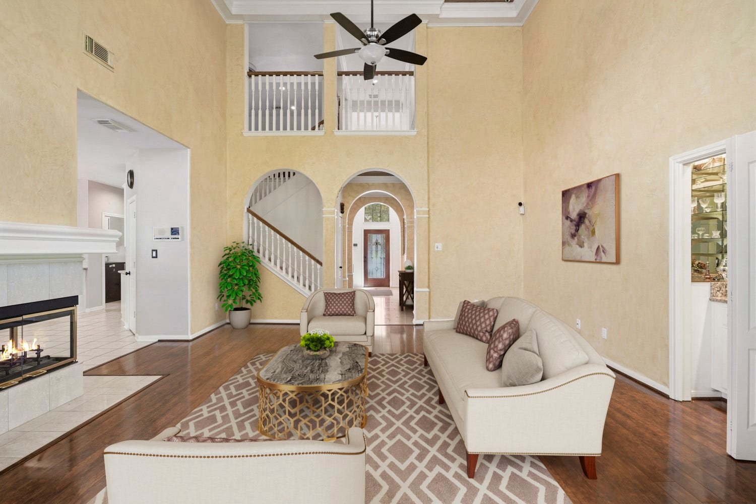 16 Fosters Court, Sugar Land, TX 77479 Virtually Staged: Architectural arches create an elegant transition to the foyer and staircase, while the upper-level overlook adds to the dramatic sense of space.