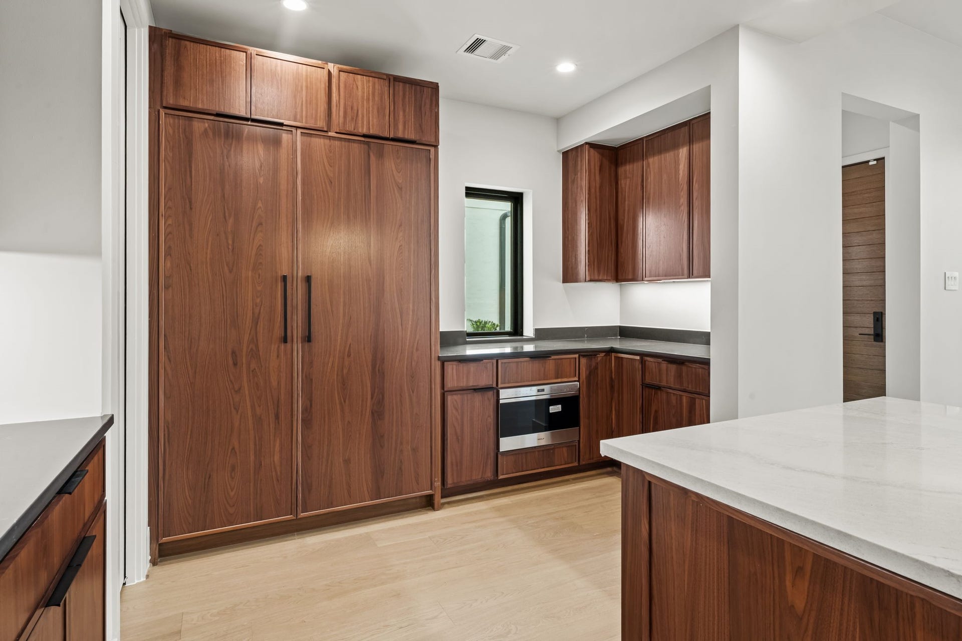 5409 Chevy Chase, #D, Houston, TX 77056 In addition to the island, there is an additional prep station to the right of the built-in fridge.