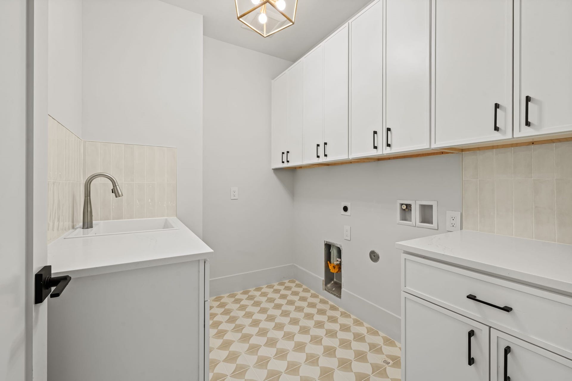 5409 Chevy Chase, #D, Houston, TX 77056 Second floor utility room with sink, folding counter, and ample cabinet space.