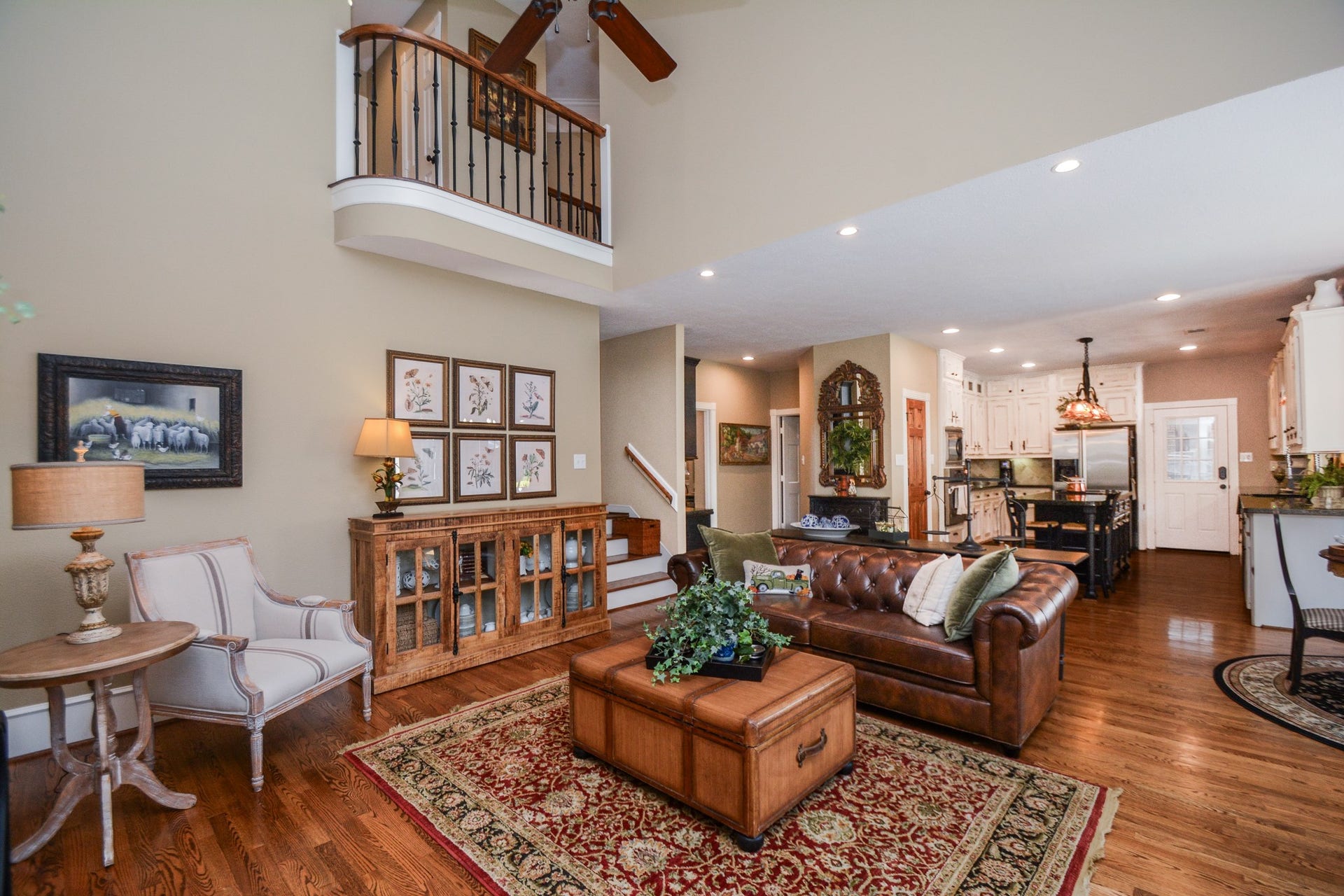 This spacious family room opens to the kitchen and features an upstairs overlook that enhances its airy feel.