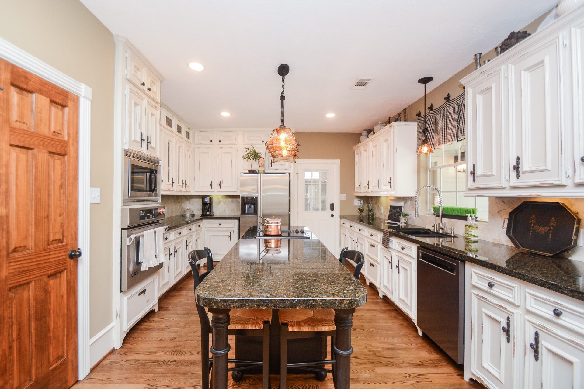 Extensive cabinetry and generous counter space provide plenty of room for meal preparation and storage in this inviting kitchen.