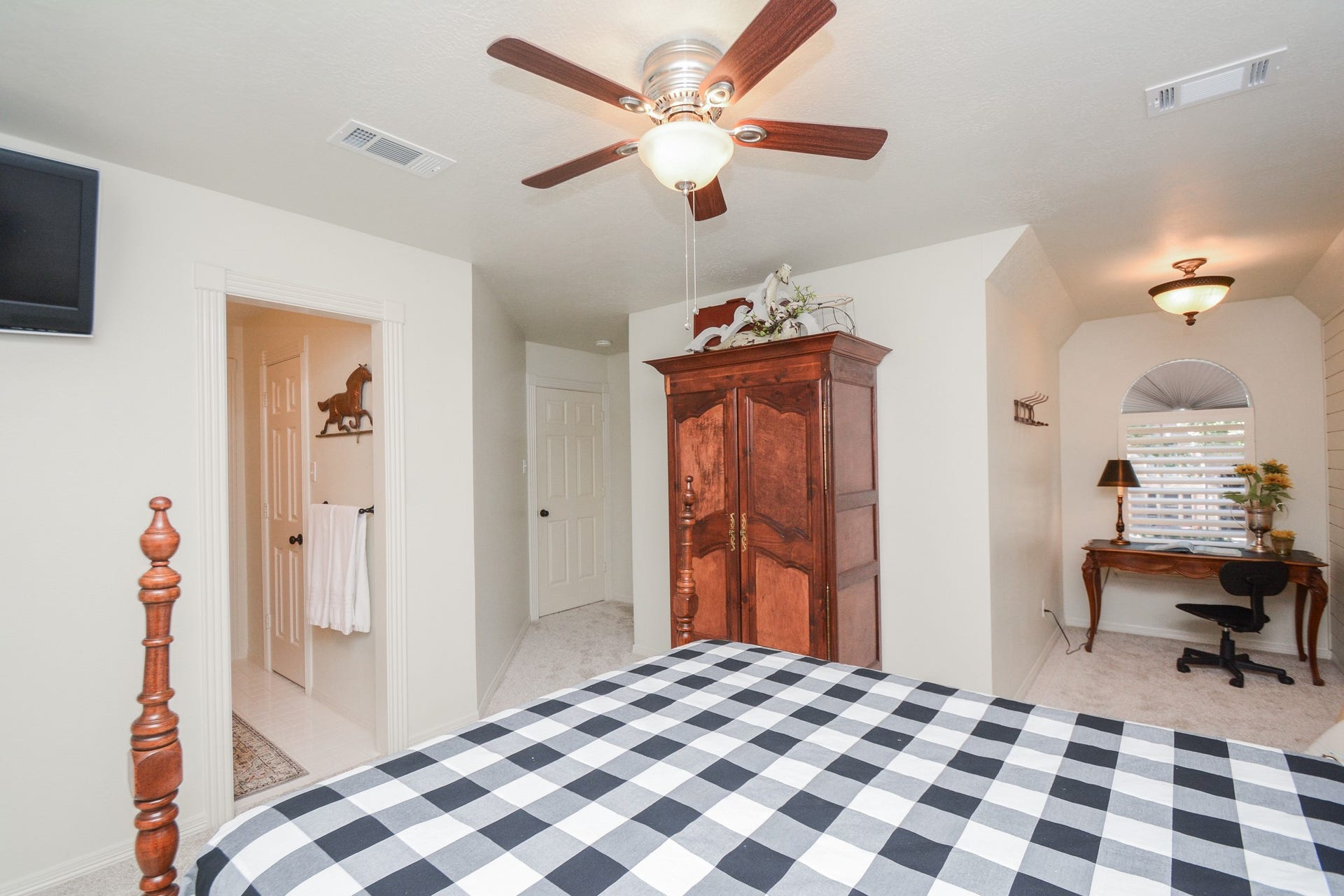 An alternate view of the secondary bedroom highlights its adjoining secluded desk nook and fresh October 2026 carpeting.