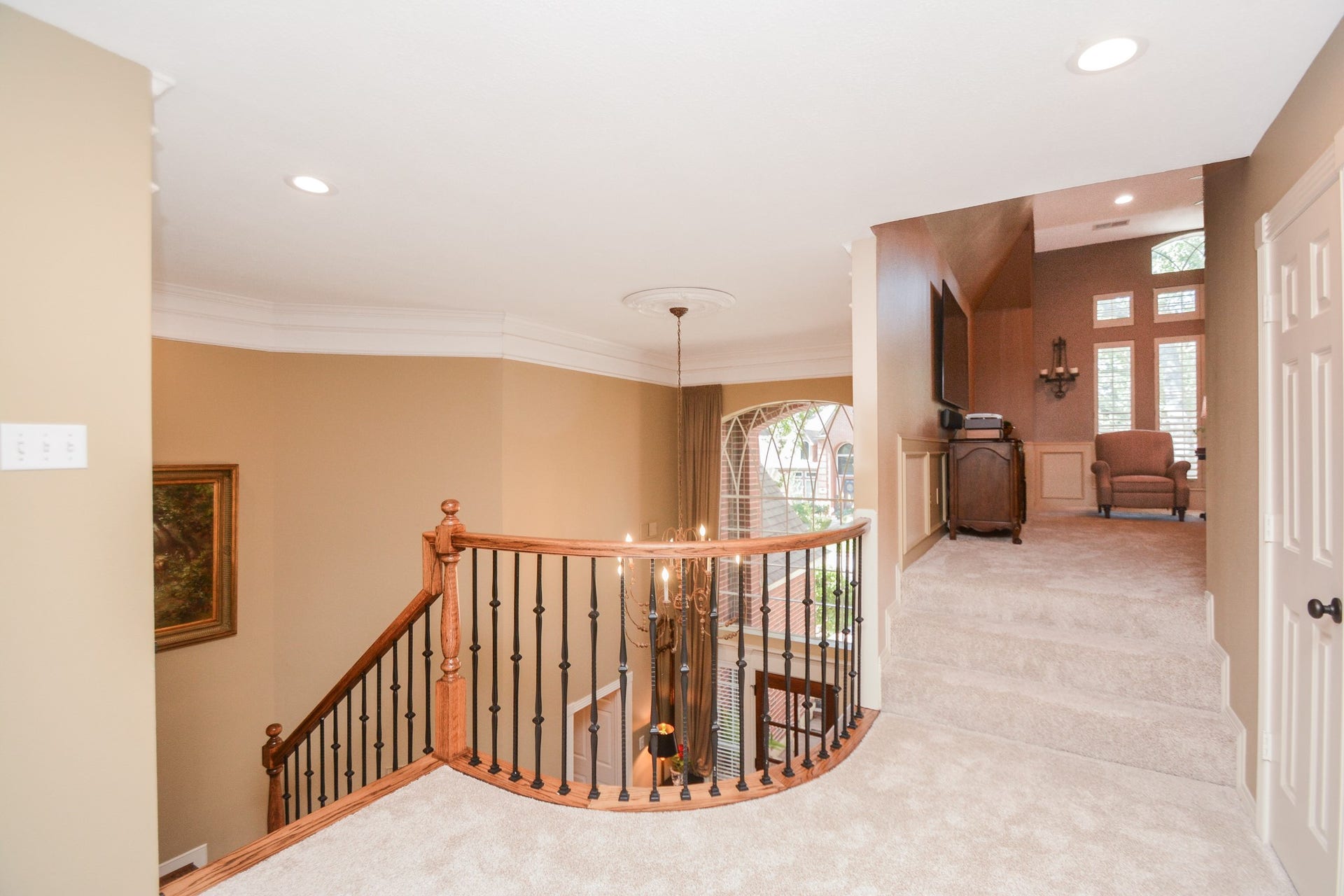 The open upstairs landing leading to the game room features decorative railings, the carpeting was replaced in October 2026.