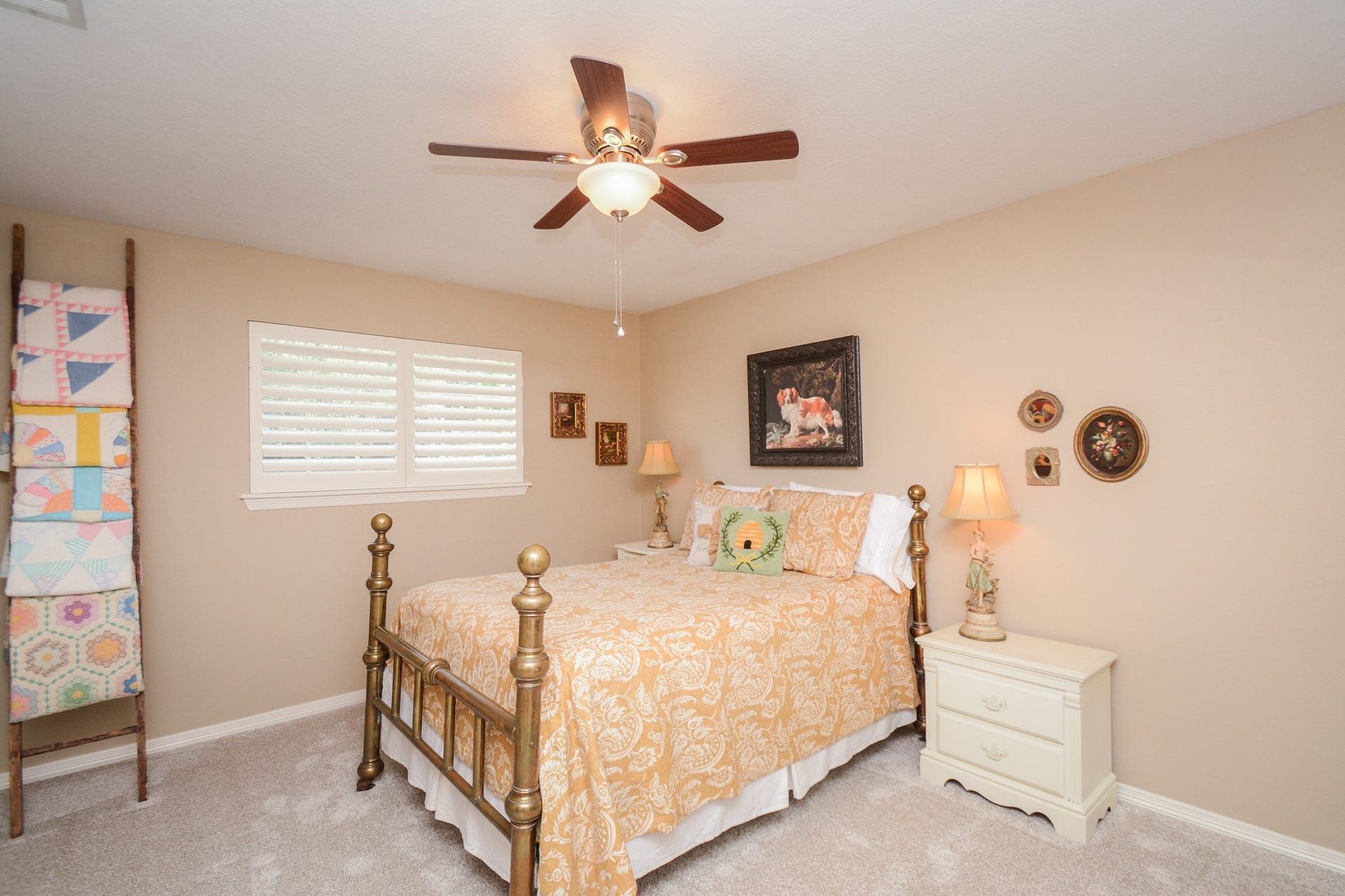 This welcoming upstairs secondary bedroom offers plantation shutters, a ceiling fan, and carpeting replaced in October 2026.