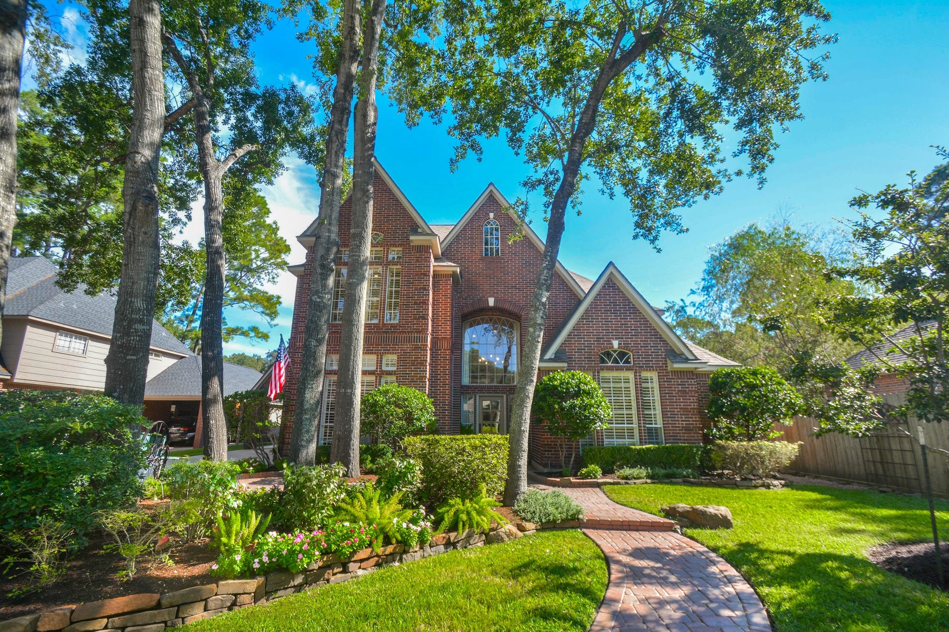 Mature trees, lush landscaping, and classic brick architecture welcome you to this home in North Houstons sought-after Champions community.