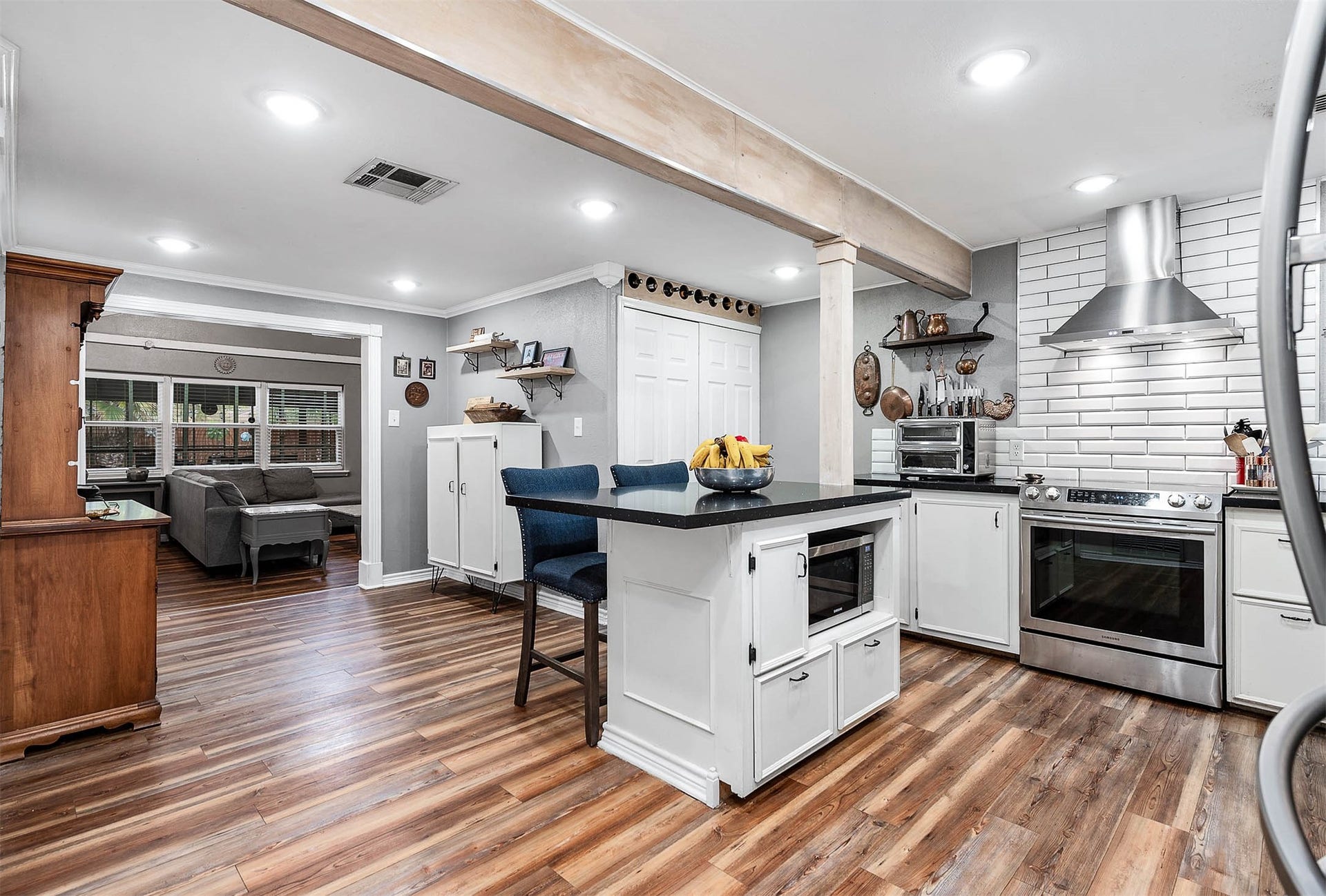 115 S Yaupon Street, Lake Jackson, TX 77566 Updated kitchen with granite counters, stainless appliances, center island and open shelving.