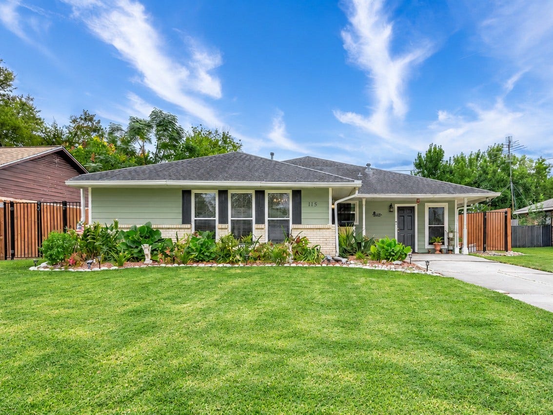 115 S Yaupon Street, Lake Jackson, TX 77566 Brick and siding exterior with full gutters, flower beds and a fenced yard.