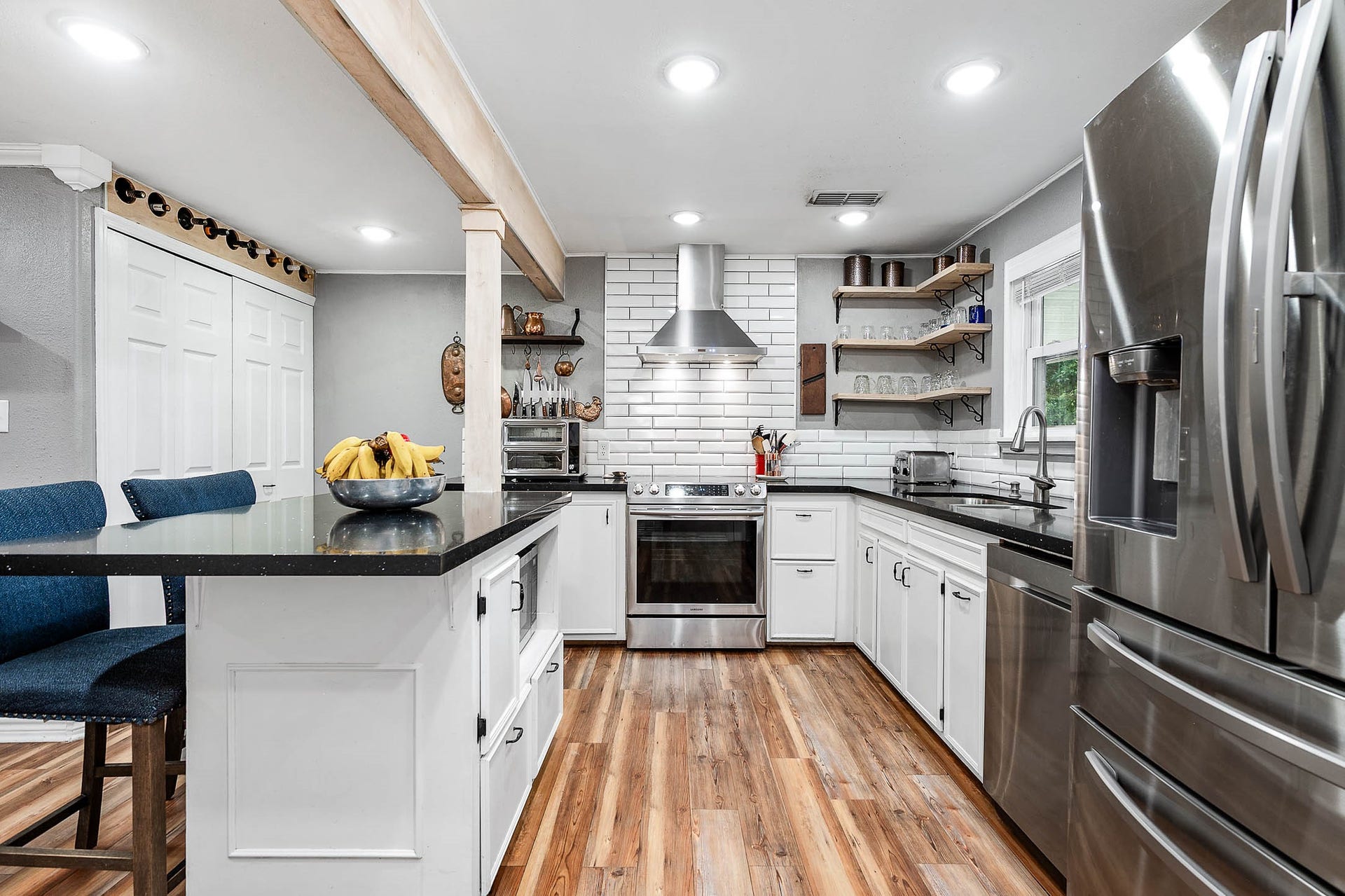 115 S Yaupon Street, Lake Jackson, TX 77566 Kitchen island with seating and generous cabinet storage; refrigerator conveys.