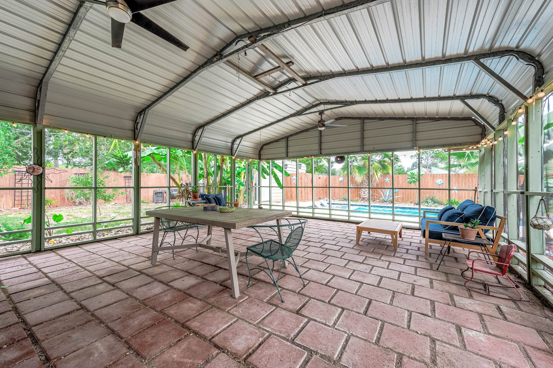 115 S Yaupon Street, Lake Jackson, TX 77566 Screened porch with ceiling fans and room for dining and lounging.