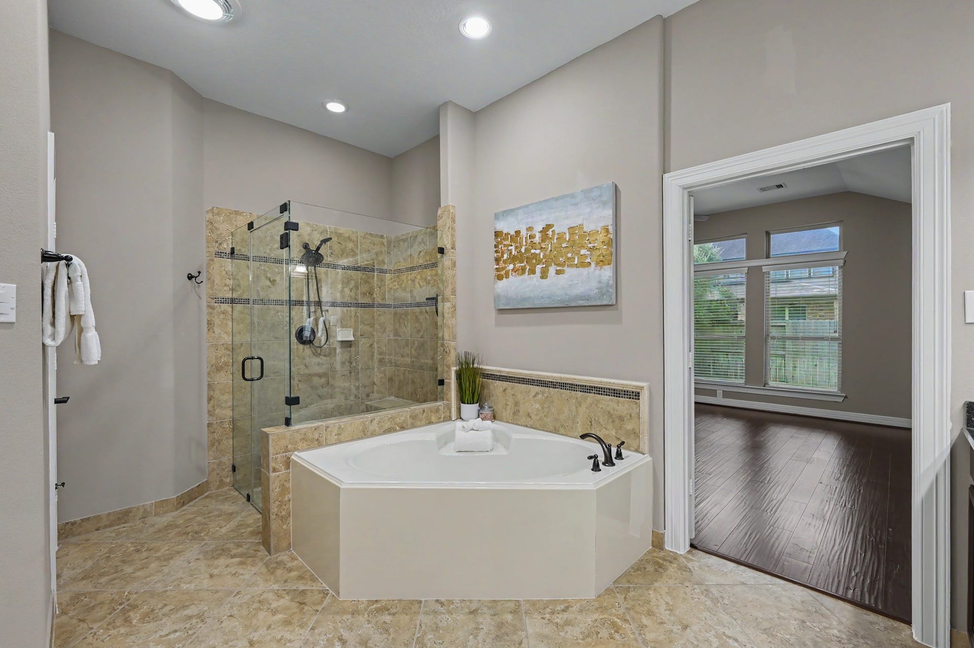 Primary bath with oversized  frameless glass walk-in shower complete with bench. Soaking tub is ready for the end of those long days, heated fan & nightlight included