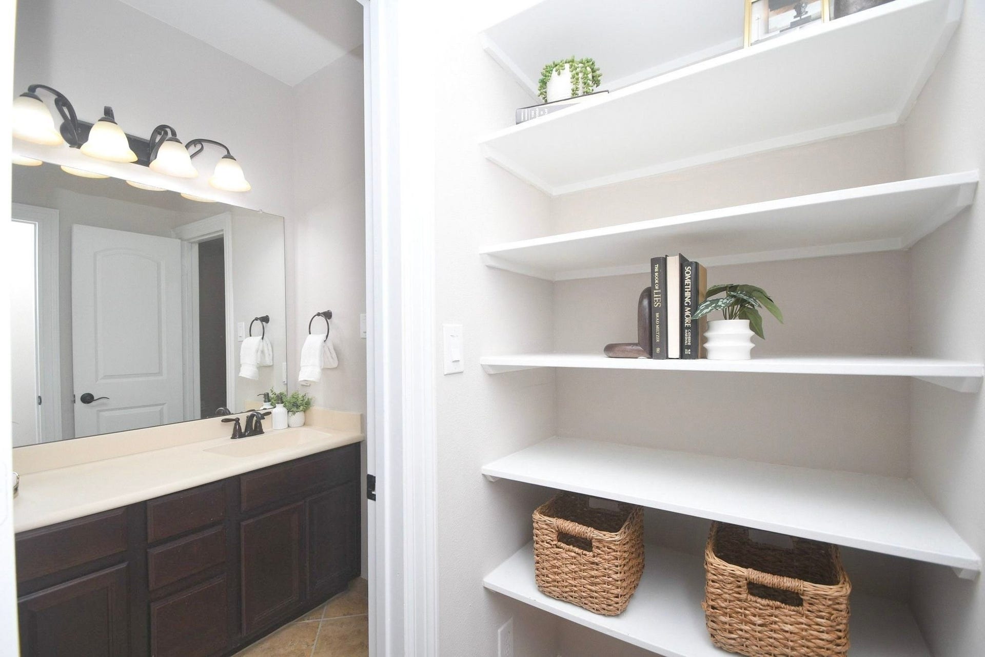 Private nook with locking closet, built-in shelving, and separate entrance to 2nd full bath.
