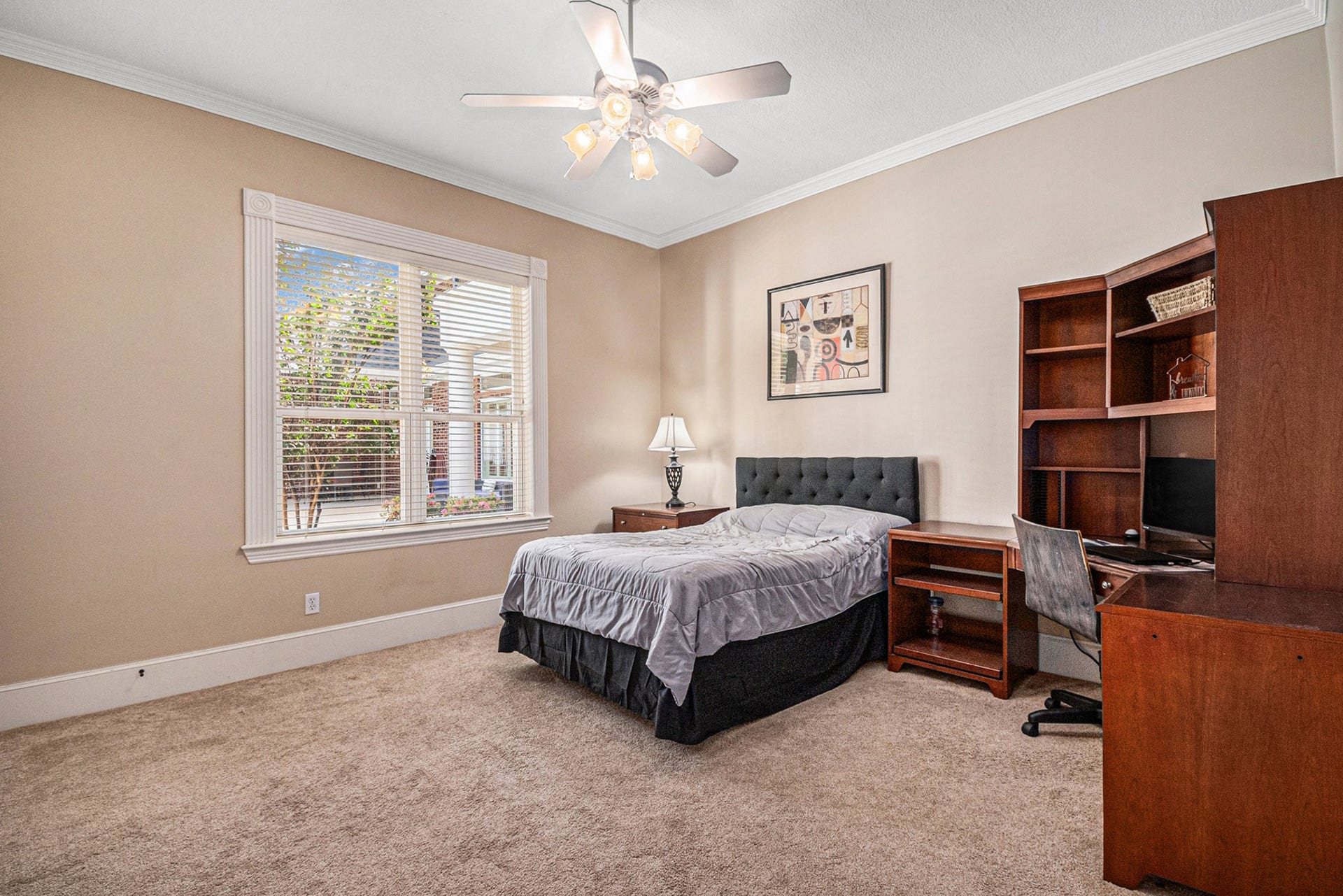 View of the spacious secondary bedroom in the guest house with great views of the backyard.