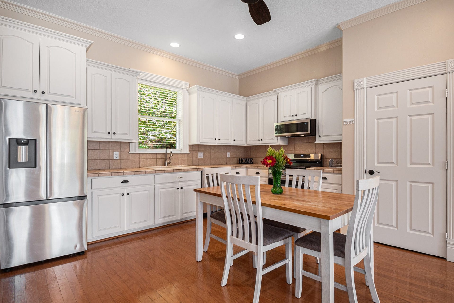 This amazing kitchen features stainless steel appliances, a breakfast nook, and a big pantry.