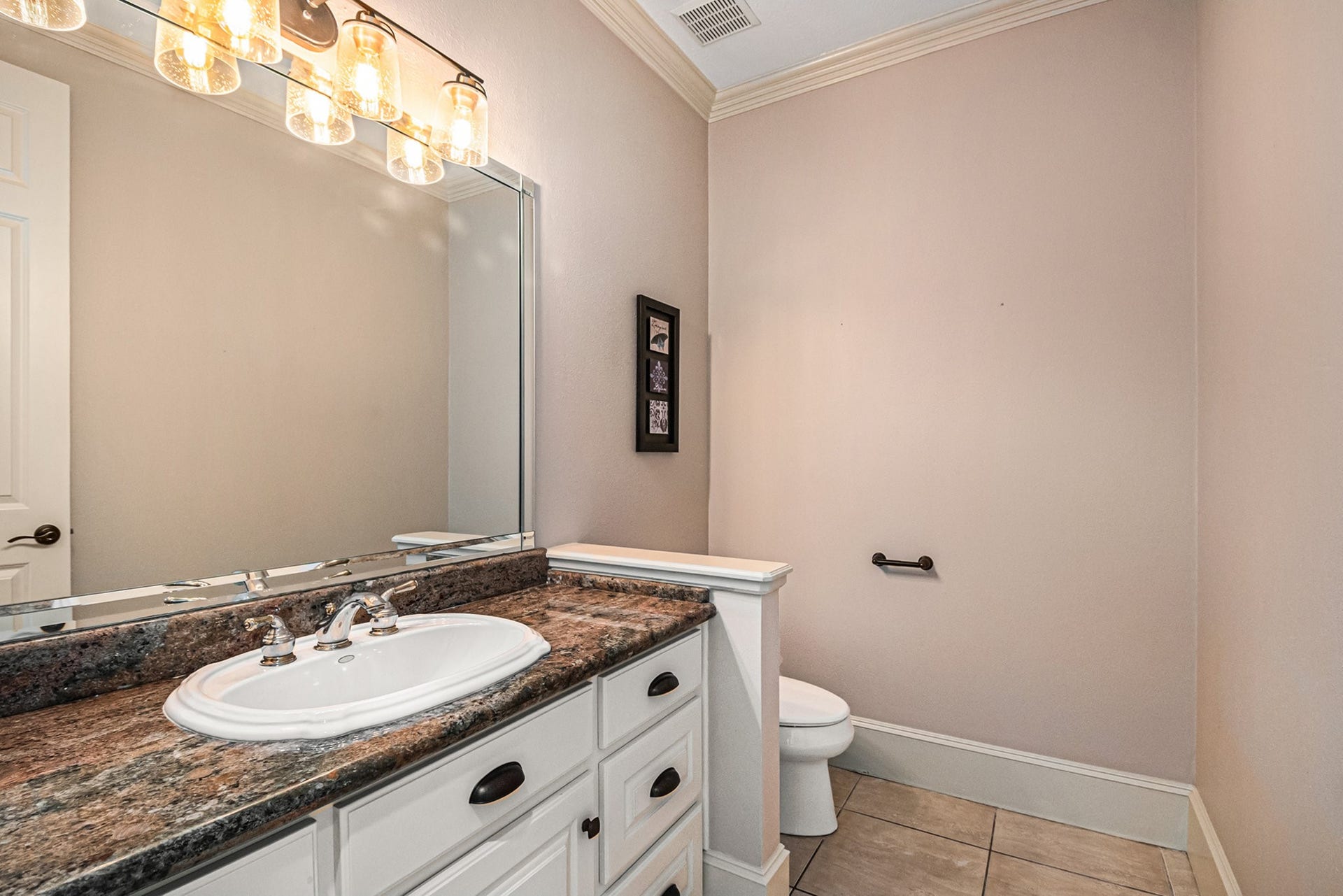 Wonderful half bath with stunning granite countertops.