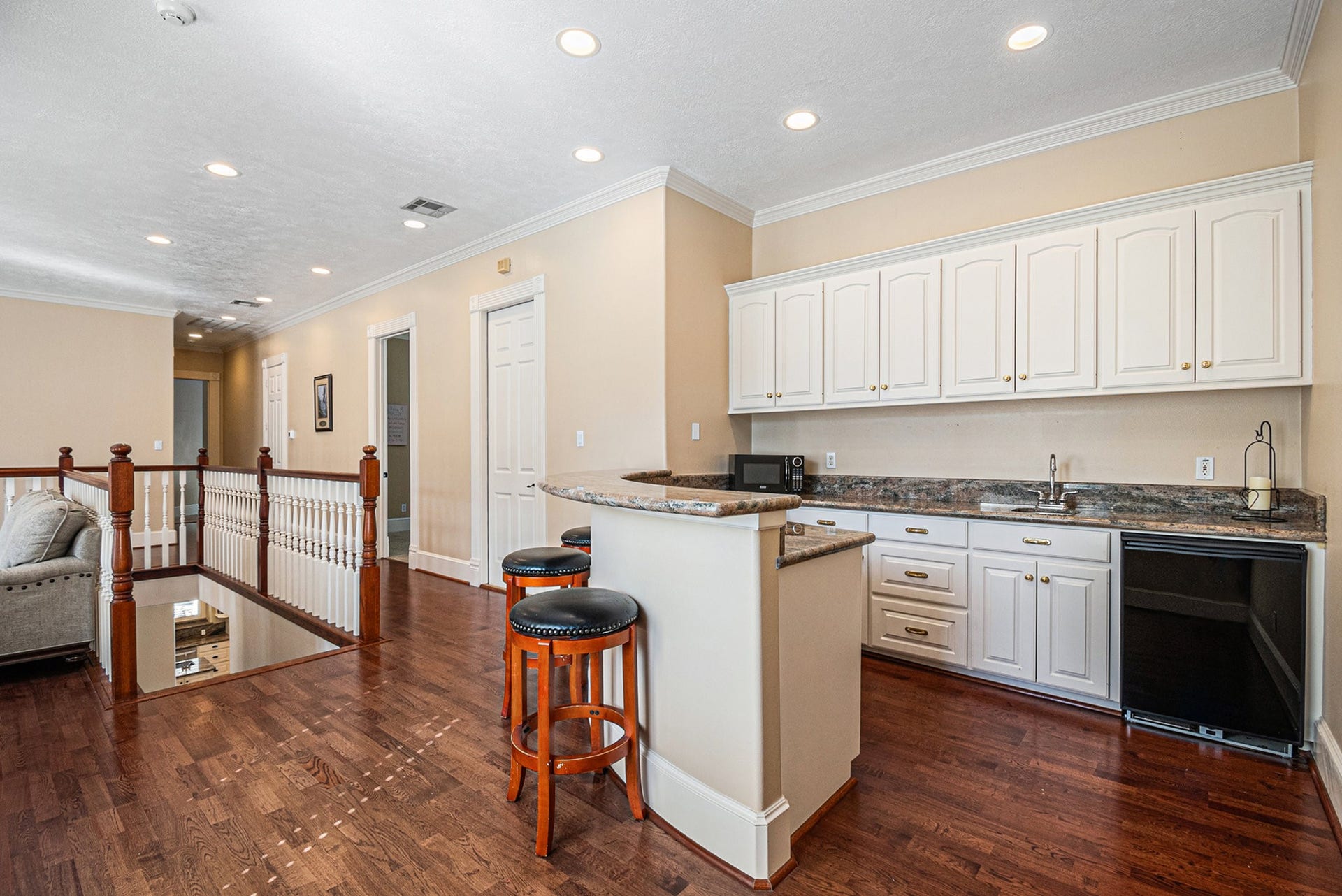 Fabulous wet bar with lots of storage, a dishwasher, and breakfast bar seating.